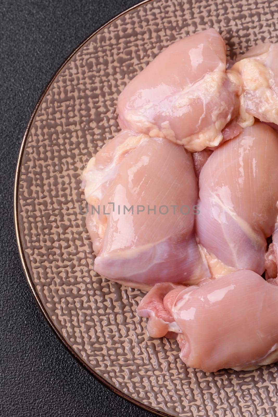 Chicken thigh fillet raw, skinless, boneless, poultry legs with salt and spices