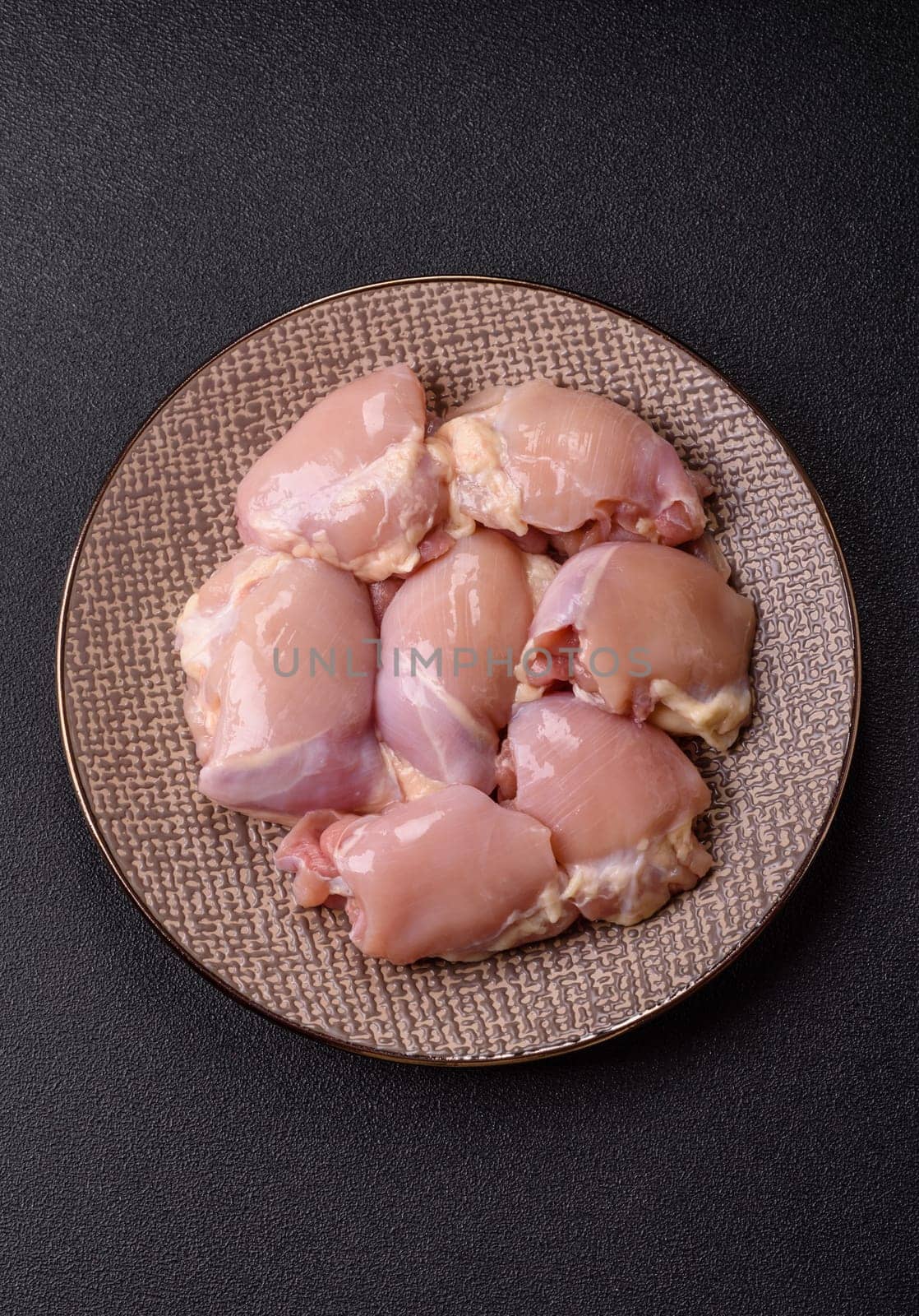 Chicken thigh fillet raw, skinless, boneless, poultry legs with salt and spices