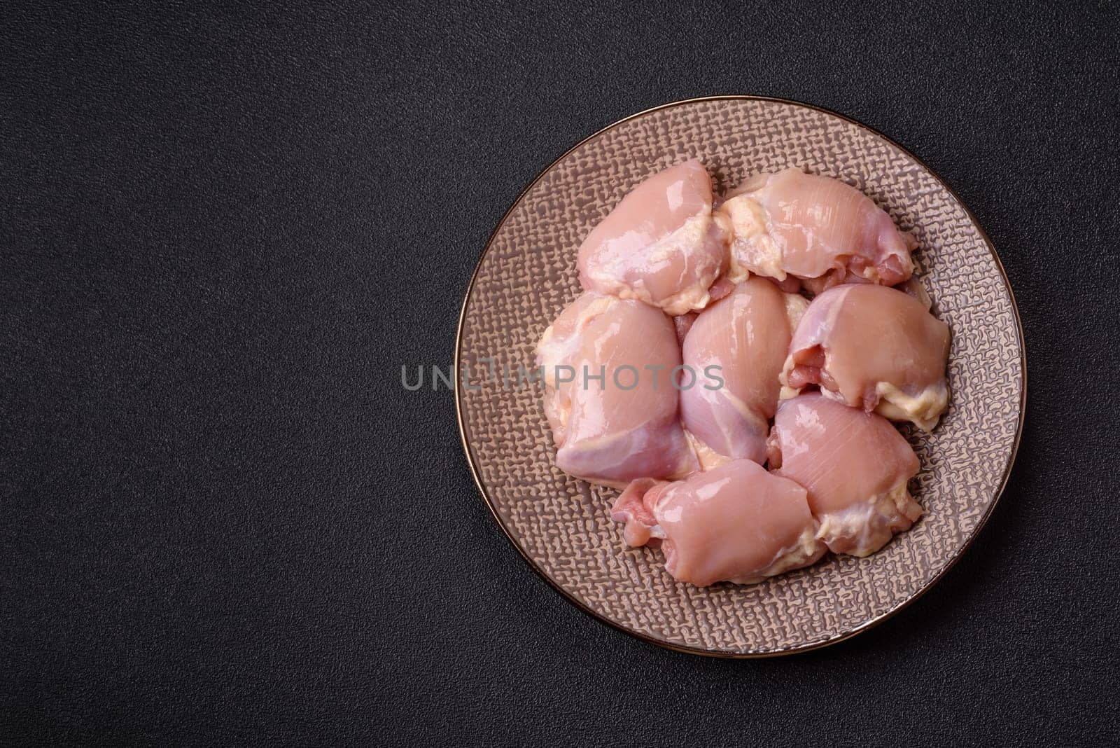 Chicken thigh fillet raw, skinless, boneless, poultry legs with salt and spices
