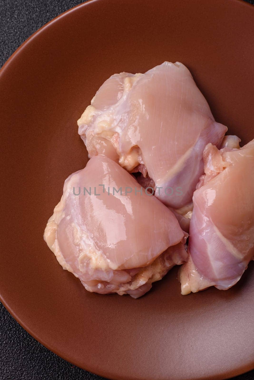 Chicken thigh fillet raw, skinless, boneless, poultry legs with salt and spices