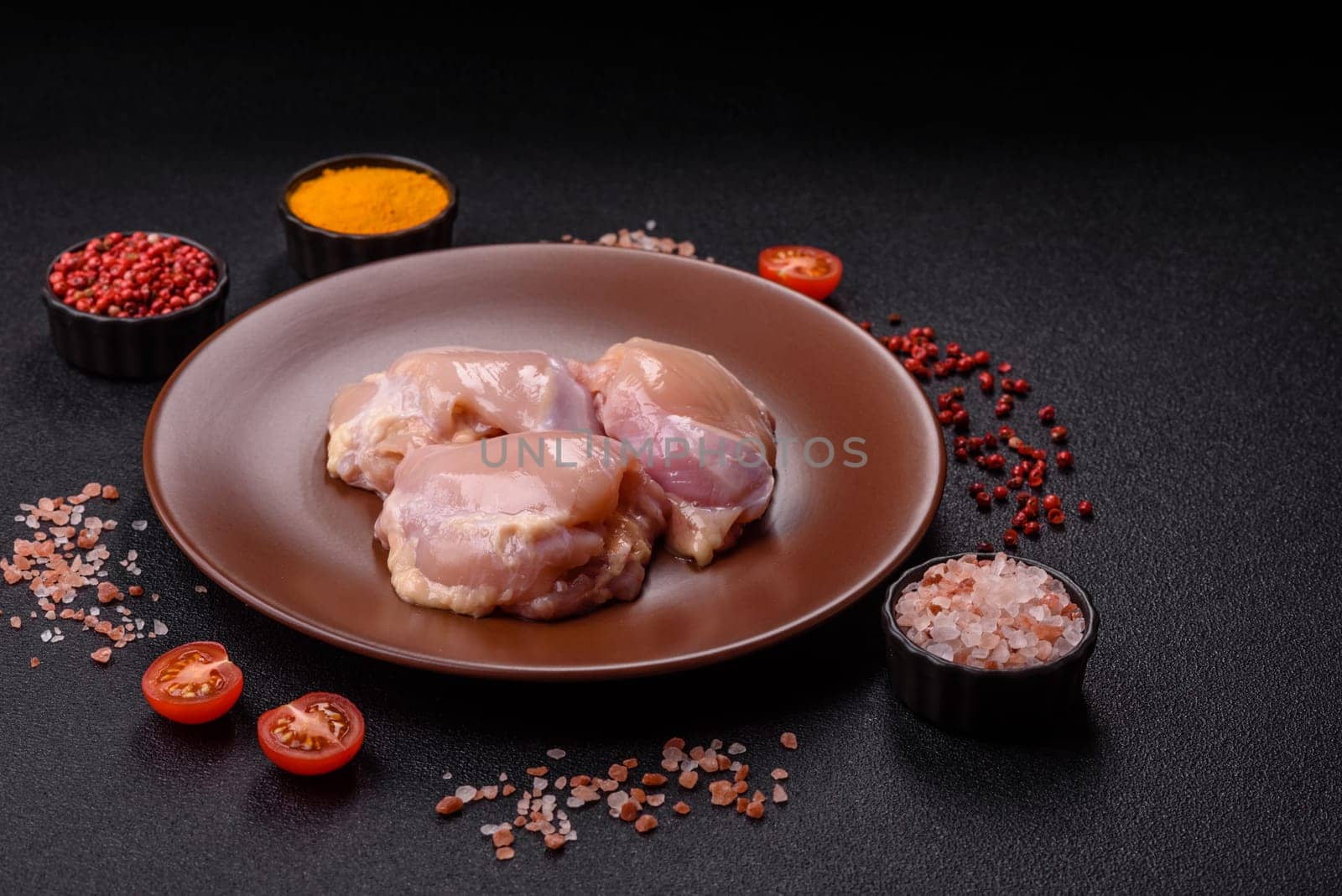 Chicken thigh fillet raw, skinless, boneless, poultry legs with salt and spices