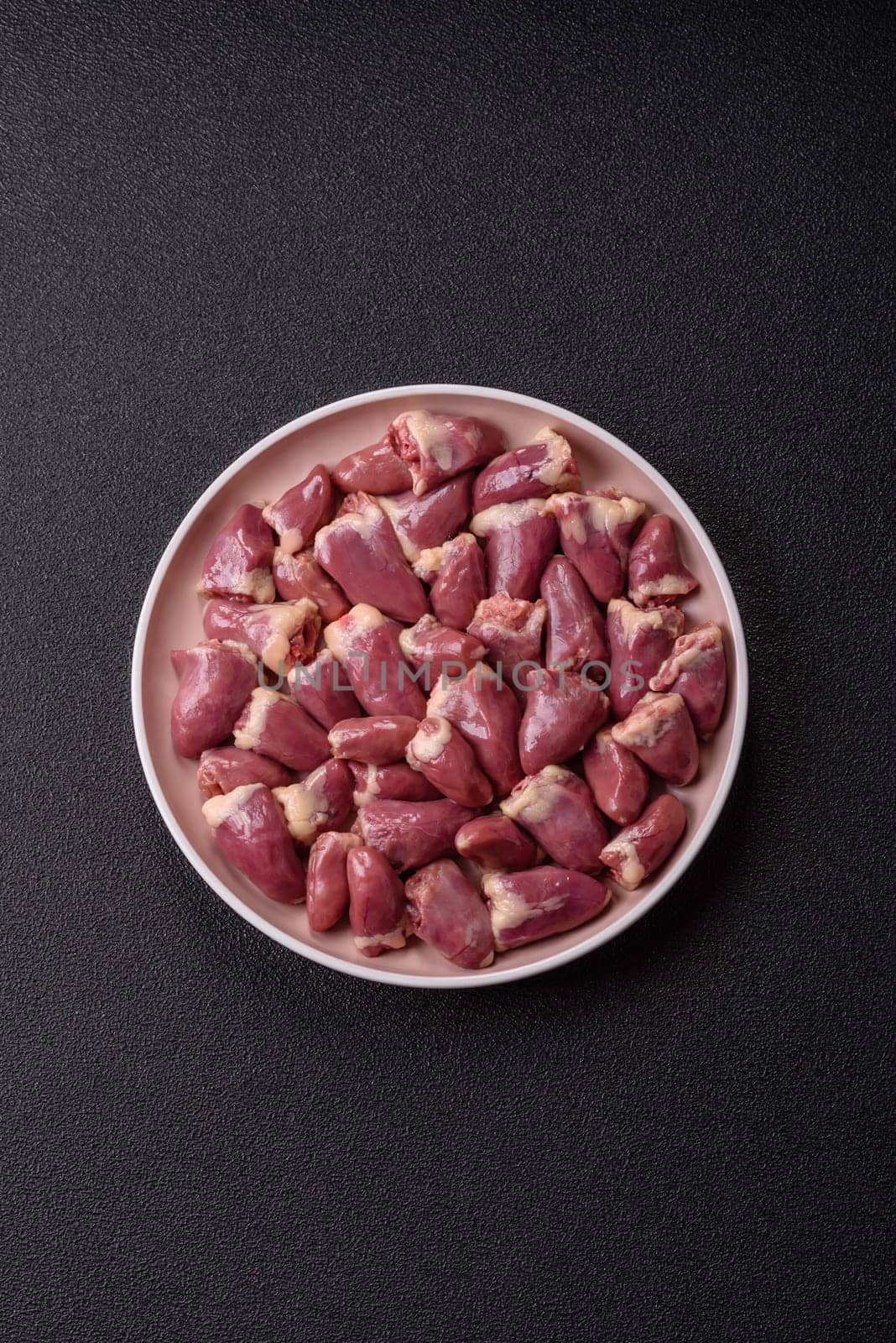 Chicken raw heart, red duck or turkey internal organs as an ingredient for dinner preparation