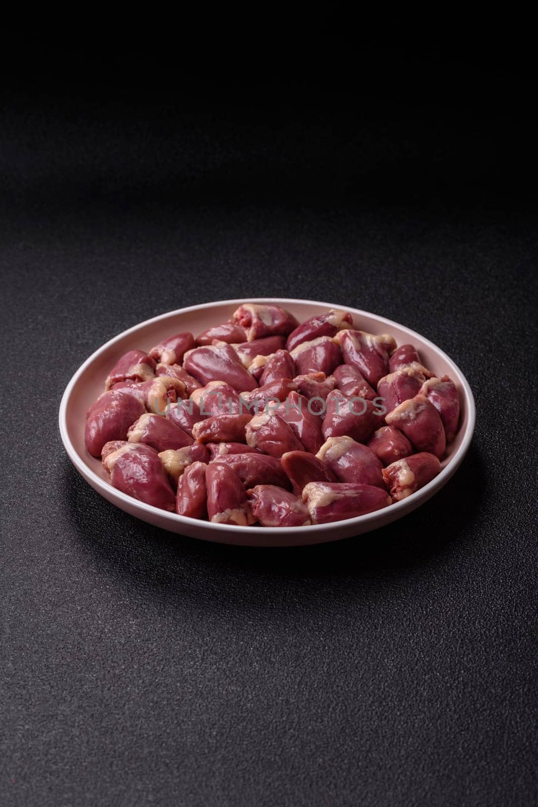 Chicken raw heart, red duck or turkey internal organs as an ingredient for dinner preparation