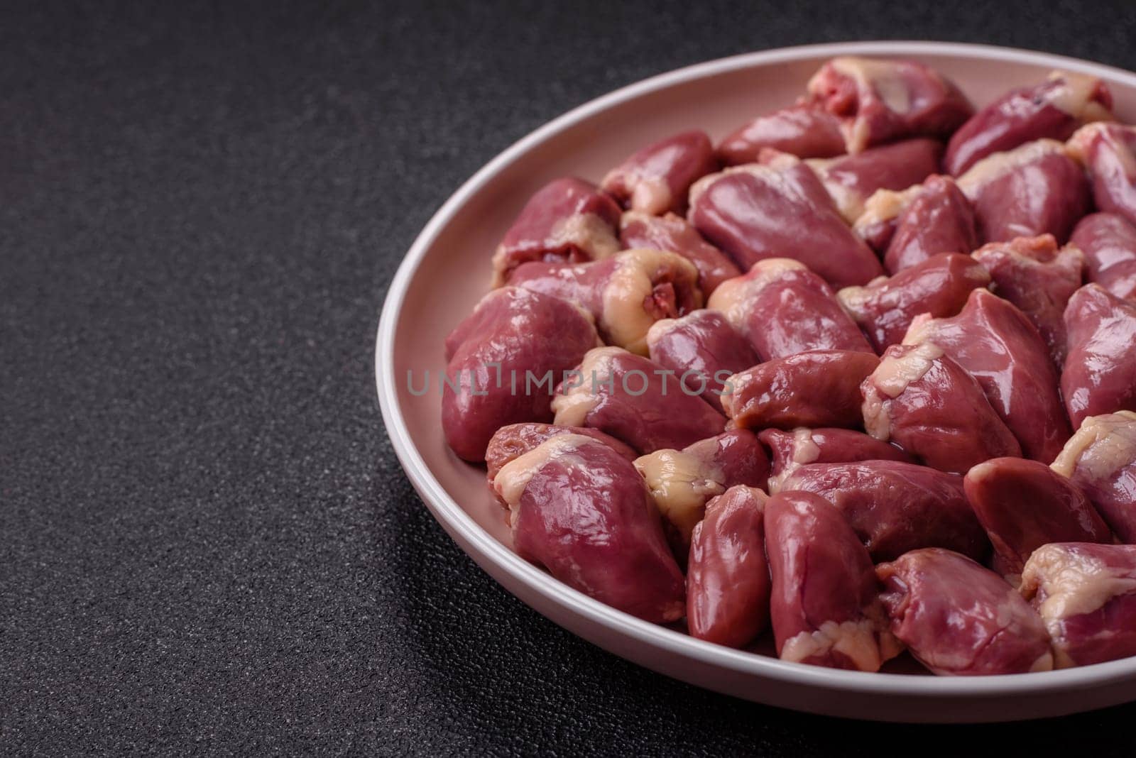 Chicken raw heart, red duck or turkey internal organs as an ingredient for dinner preparation