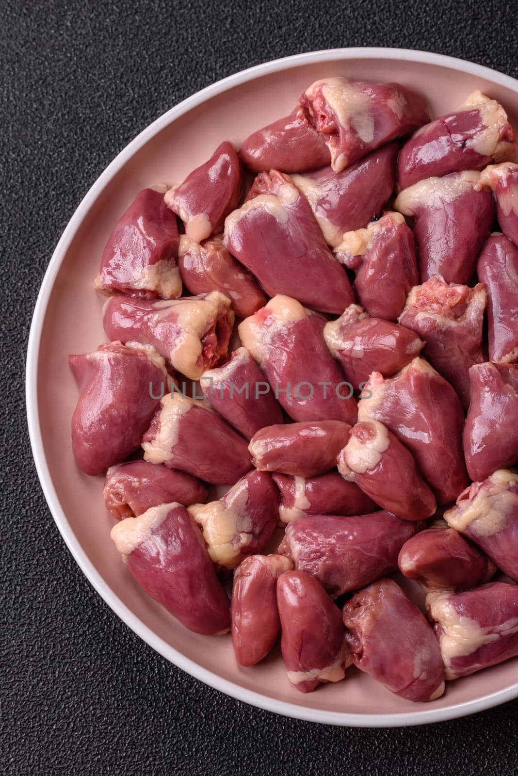 Chicken raw heart, red duck or turkey internal organs as an ingredient for dinner preparation