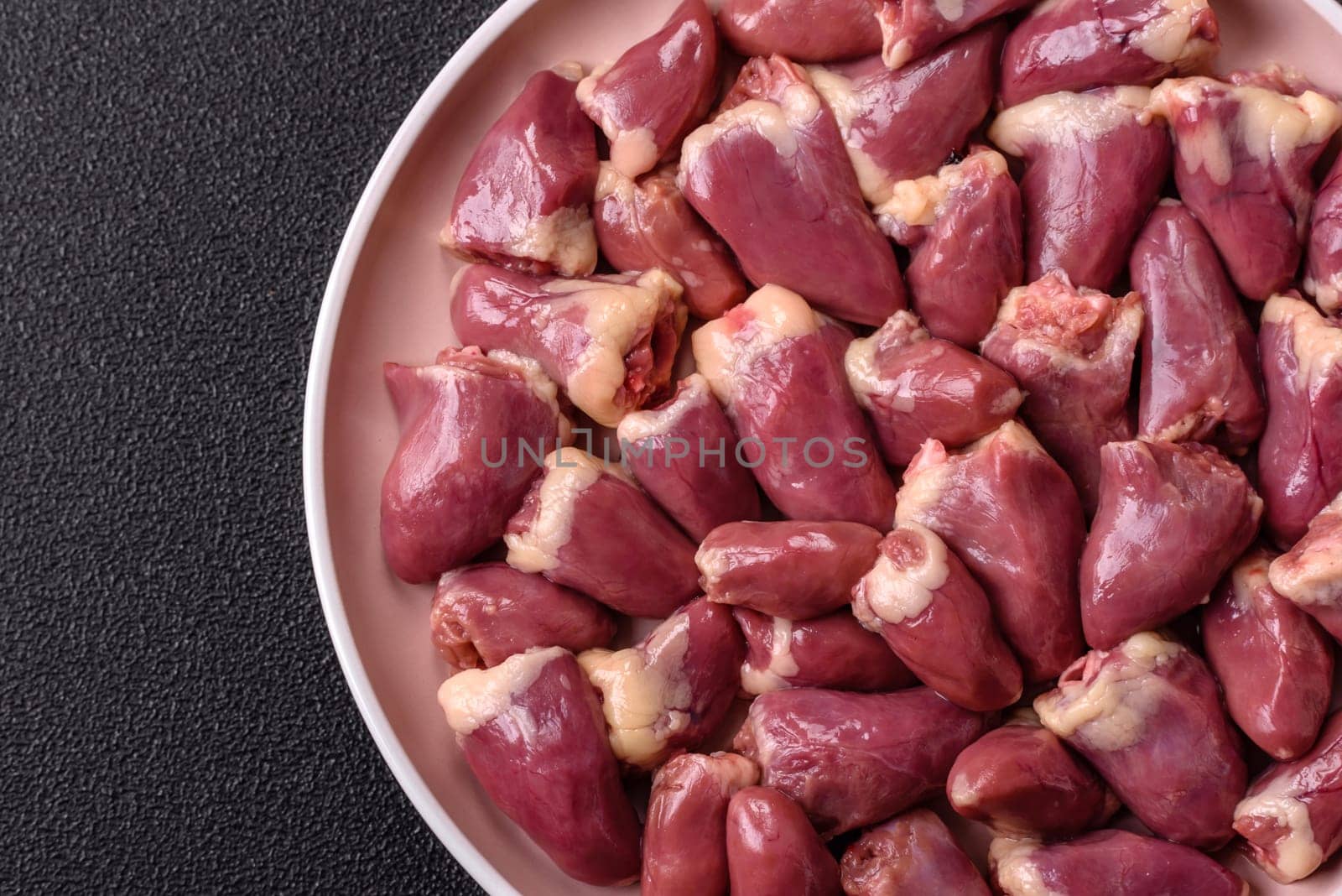 Chicken raw heart, red duck or turkey internal organs as an ingredient for dinner preparation