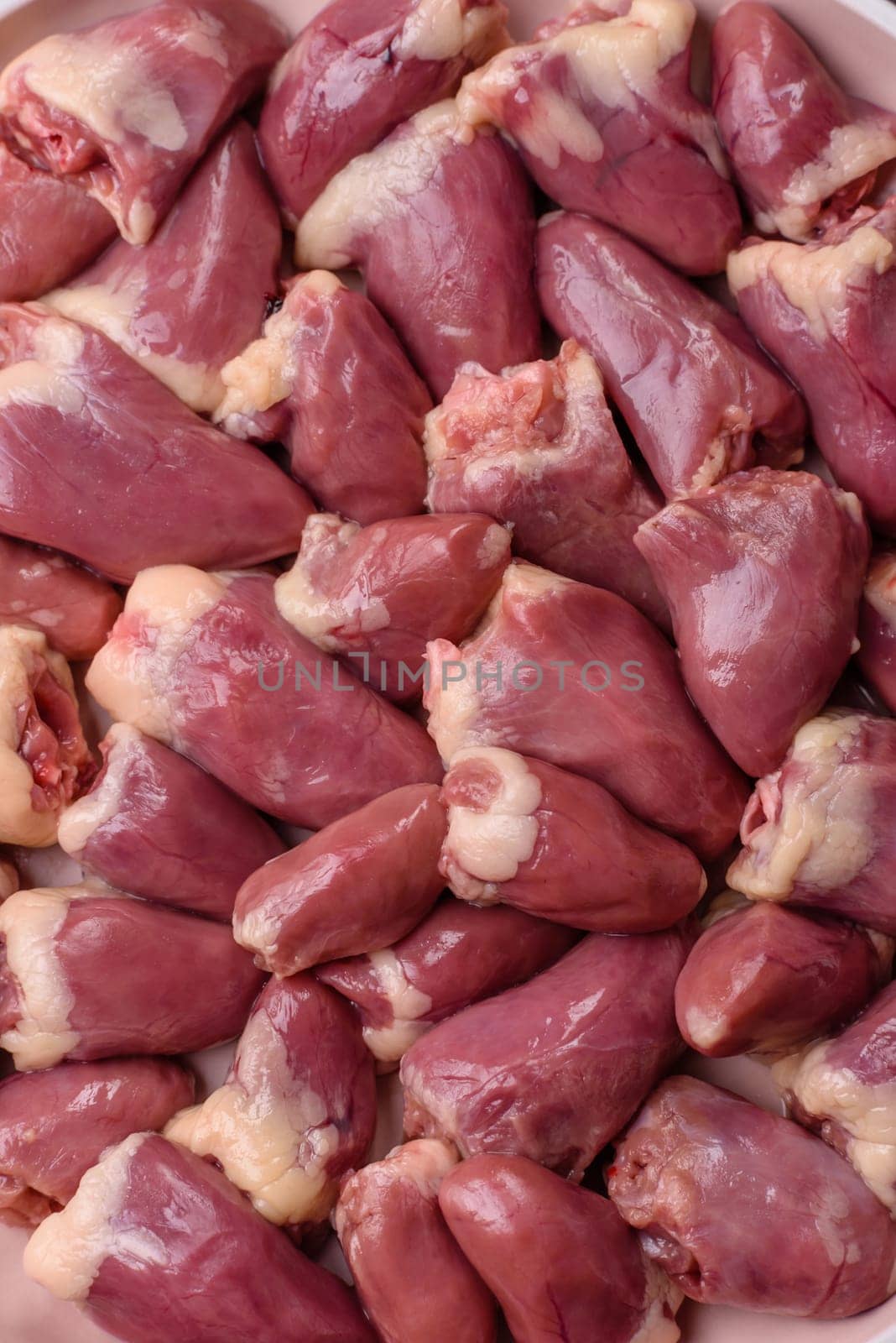 Chicken raw heart, red duck or turkey internal organs as an ingredient for dinner preparation