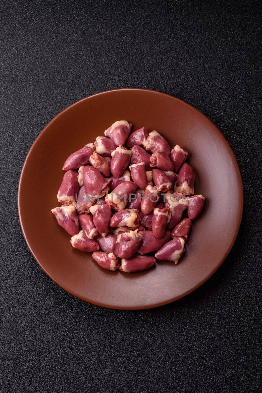 Chicken raw heart, red duck or turkey internal organs as an ingredient for dinner preparation