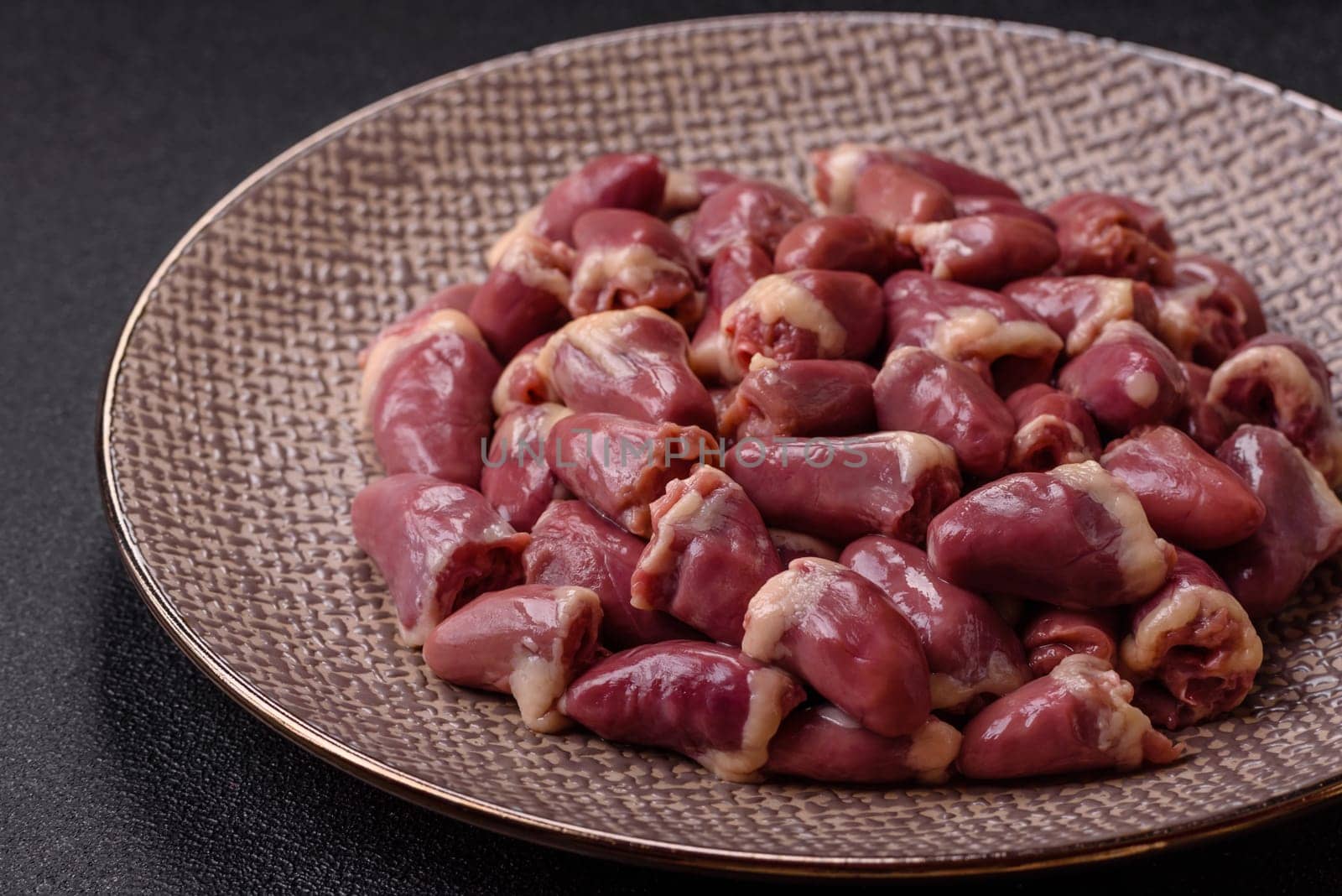 Chicken raw heart, red duck or turkey internal organs as an ingredient for dinner preparation