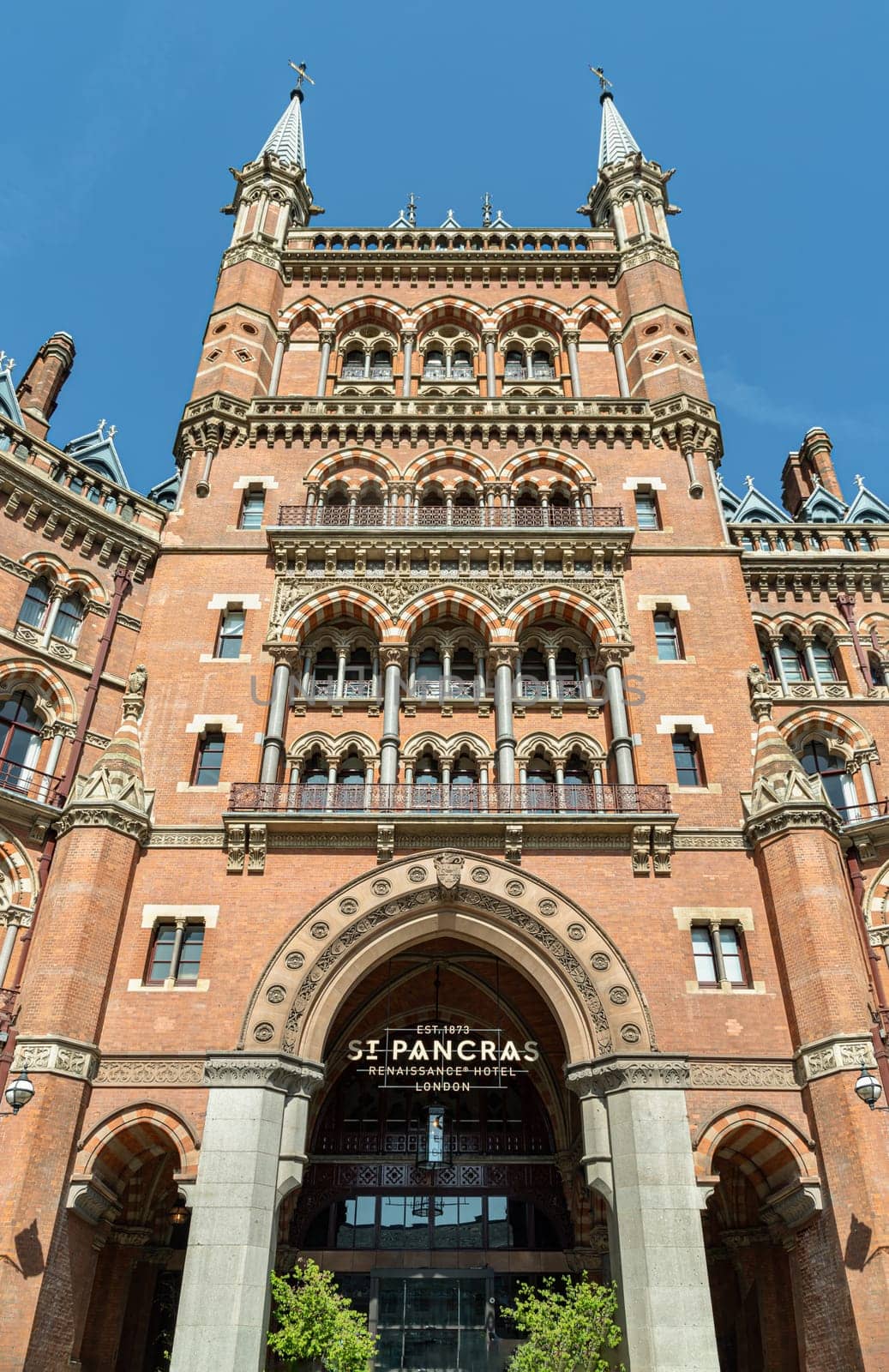London, UK - Apr 11, 2025 - A view and outside entrance of the gothic building where the St. Pancras Renaissance Hotel is based in Kings Cross. Facade of Victorian architecture at the Midland Grand Hotel, use it as your Wallpaper, Poster and Space for text, Selective focus.