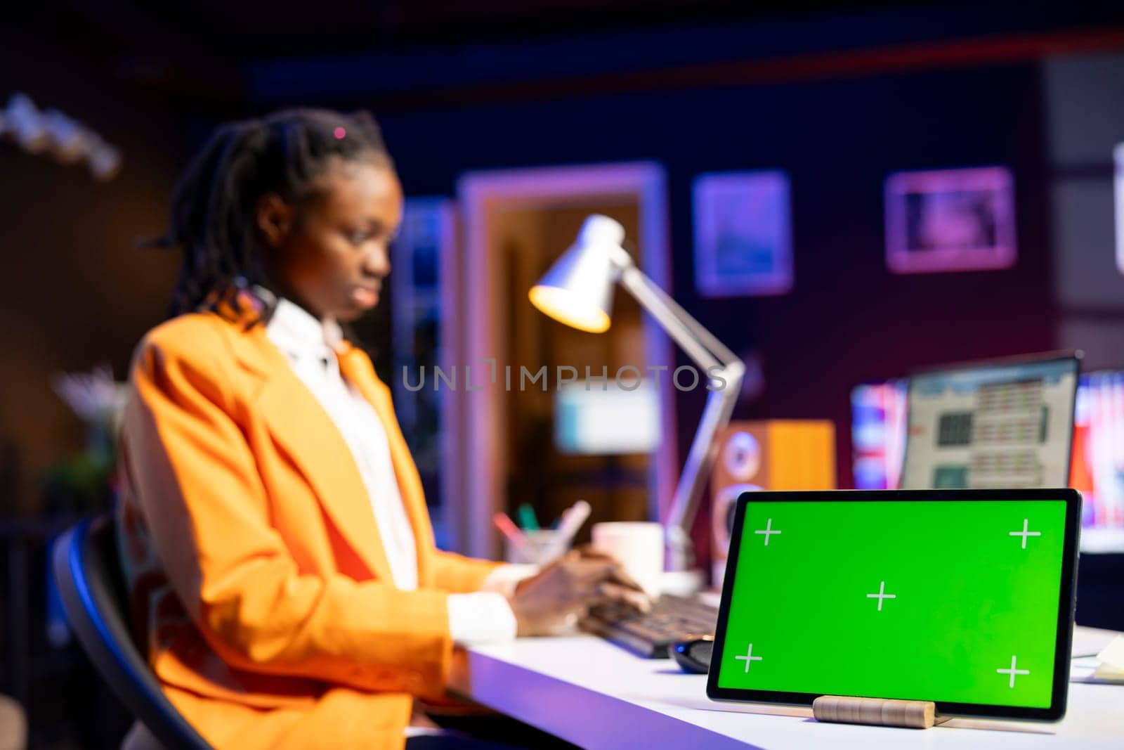 Close up of isolated screen tablet used by broker investor watching videos while checking stock exchange valuation. Stockholder looking at market shares growth on laptop and mockup device