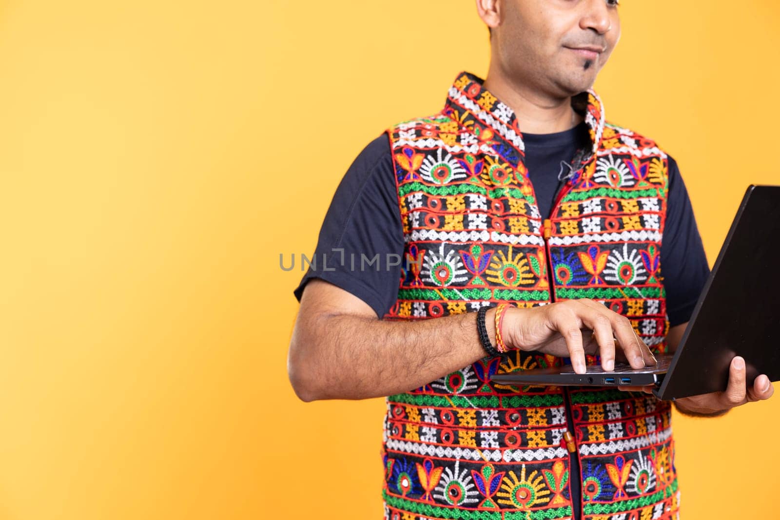 Worker typing on laptop, doing business related tasks, isolated over studio backdrop. Close up shot of person doing budgeting, forecasting, and financial analysis on notebook