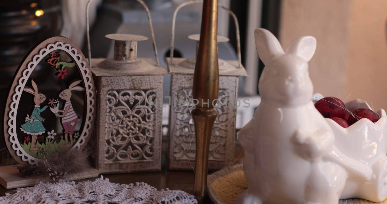 Colorful Easter decorations enhance a spring home decor setting, showcasing a delightful still life with charming bunnies, vintage lanterns, and festive details.