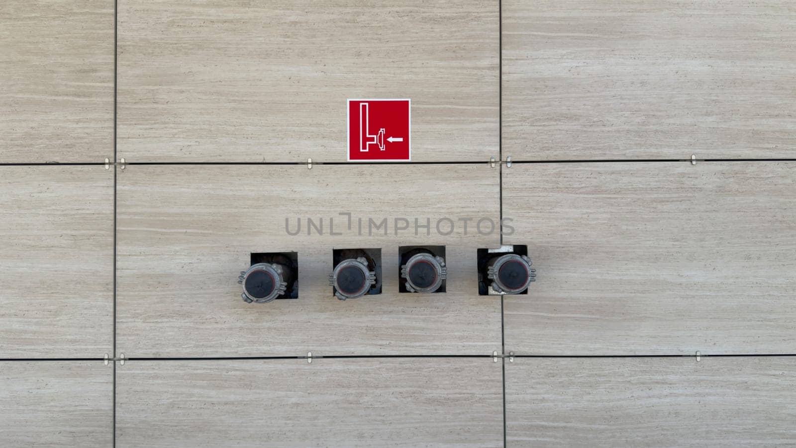 System of dry riser with pipe outlets to street to ensure safety in building. Pipe for connecting fire engine hose when extinguishing fire. Sign indicating of hydrant connection in case of fire