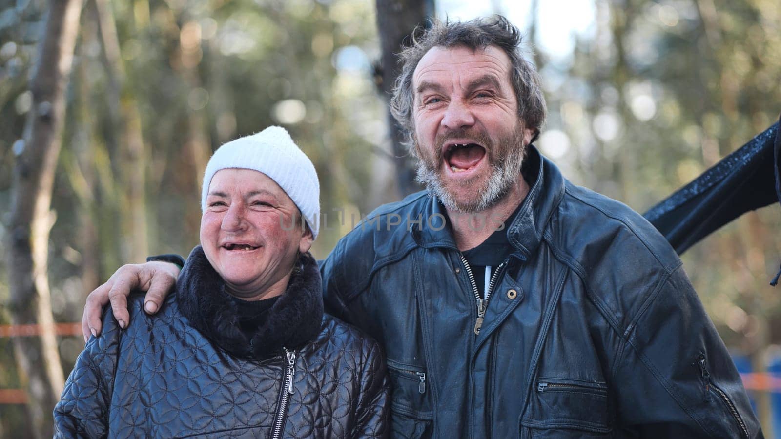Homeless couple laughing, supporting each other during cold winter street conditions, weathering challenges with shared resilience