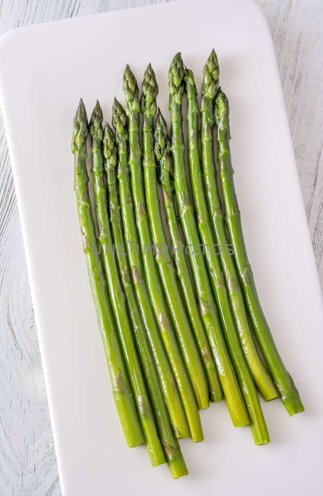 Slender stalks shine with moisture, each bright green spear cooked to perfect tenderness