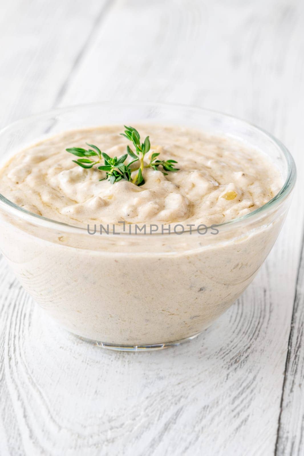 Herbed sauce glows softly as thyme floats atop rich, tangy blue cheese