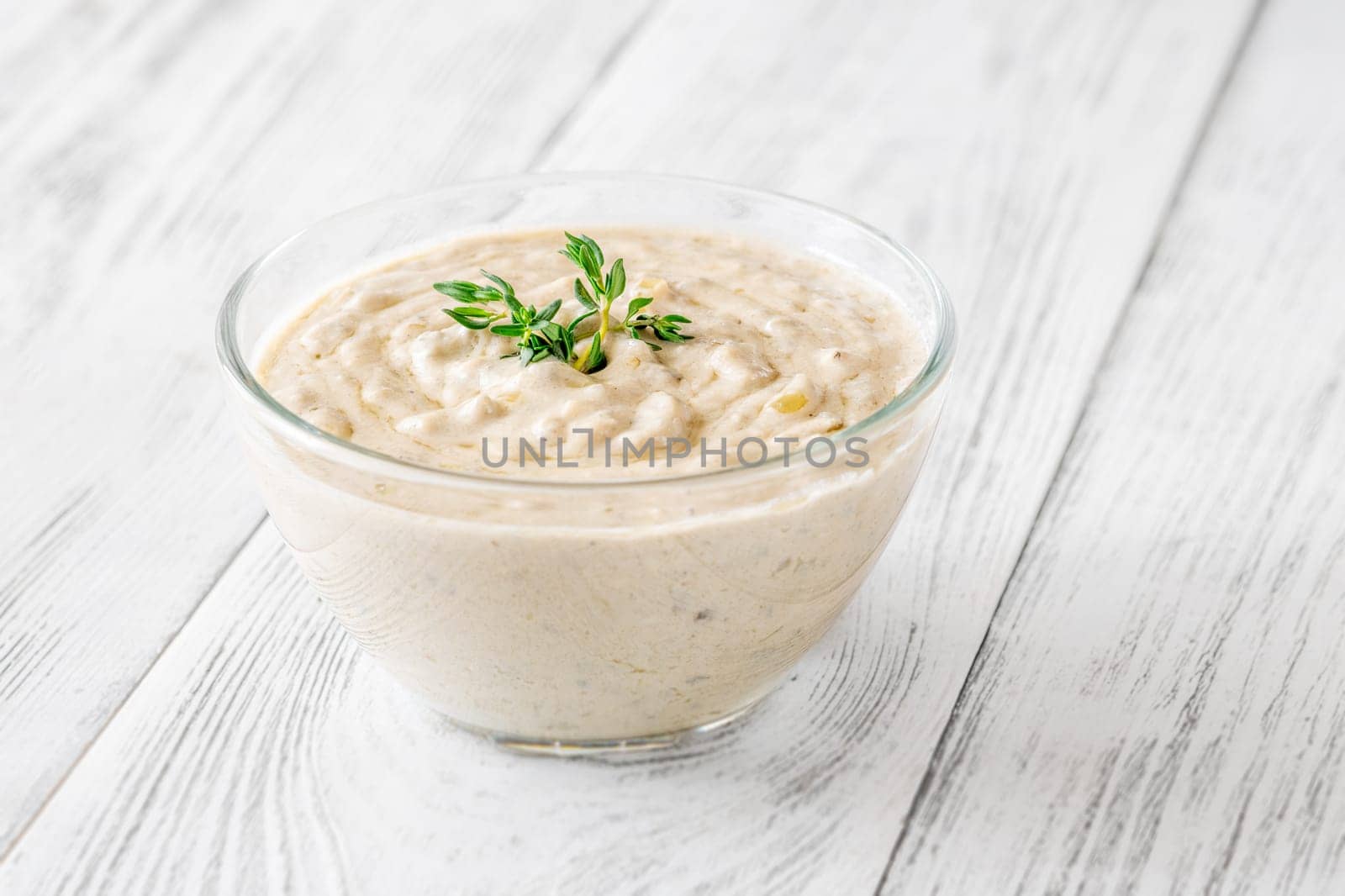 Herbed sauce glows softly as thyme floats atop rich, tangy blue cheese