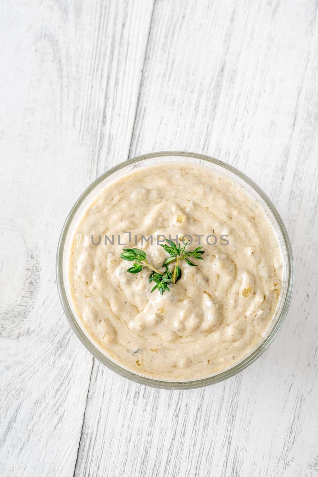 Herbed sauce glows softly as thyme floats atop rich, tangy blue cheese