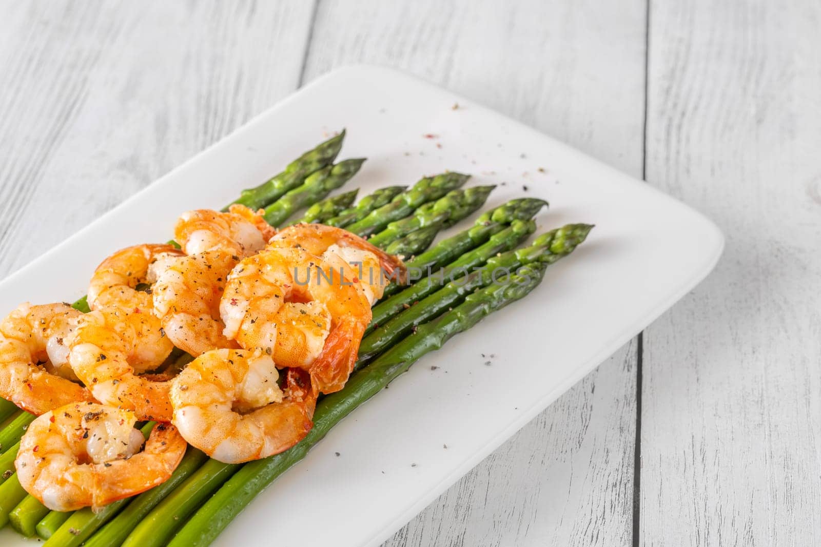 Golden shrimp add crunch and color to soft green spears of asparagus