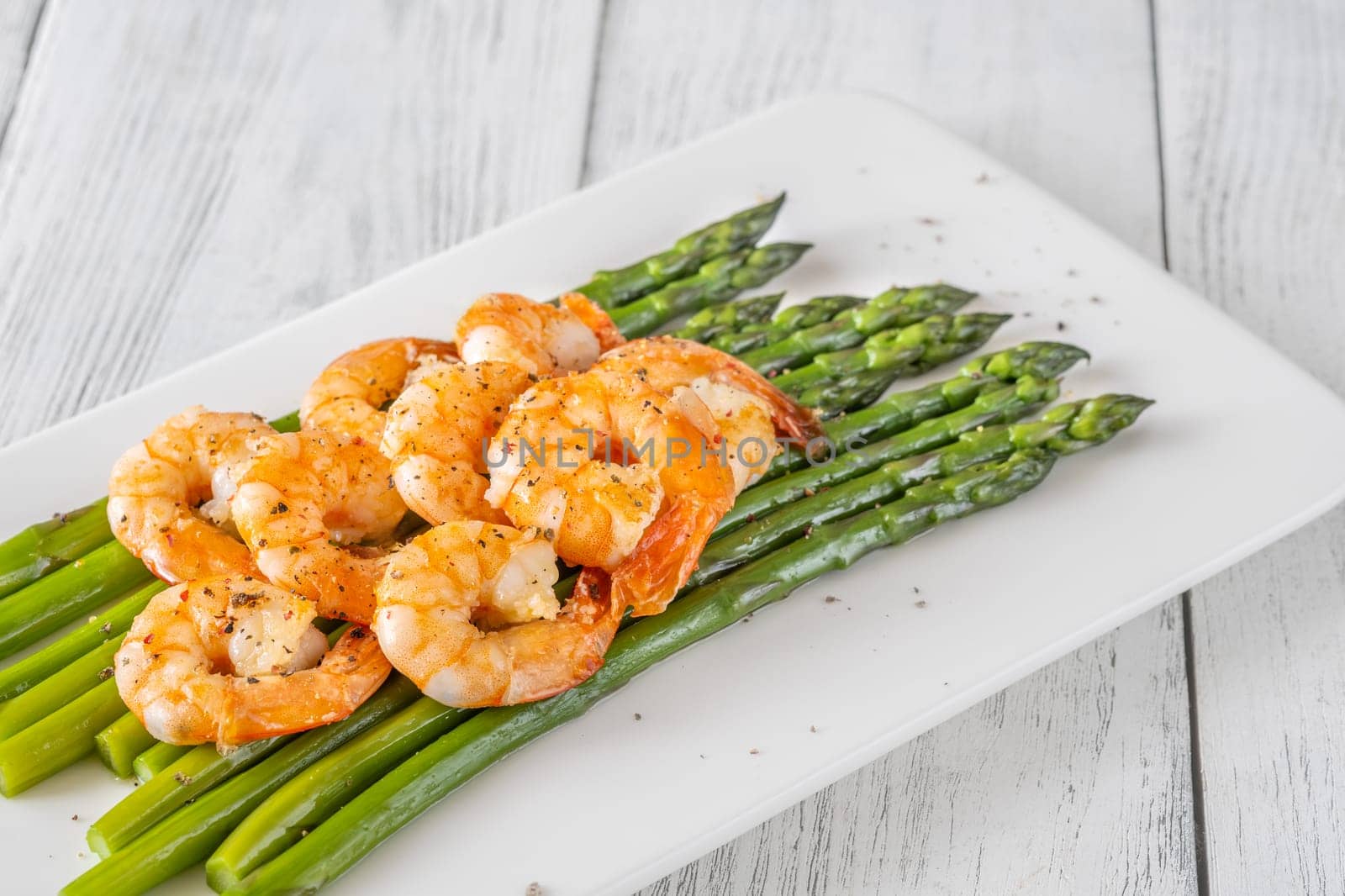 Golden shrimp add crunch and color to soft green spears of asparagus