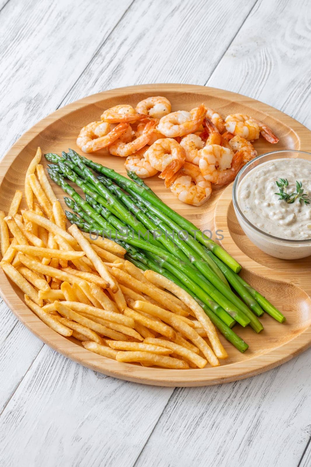 Crispy shrimp and fries balance soft asparagus and creamy sauce with thyme