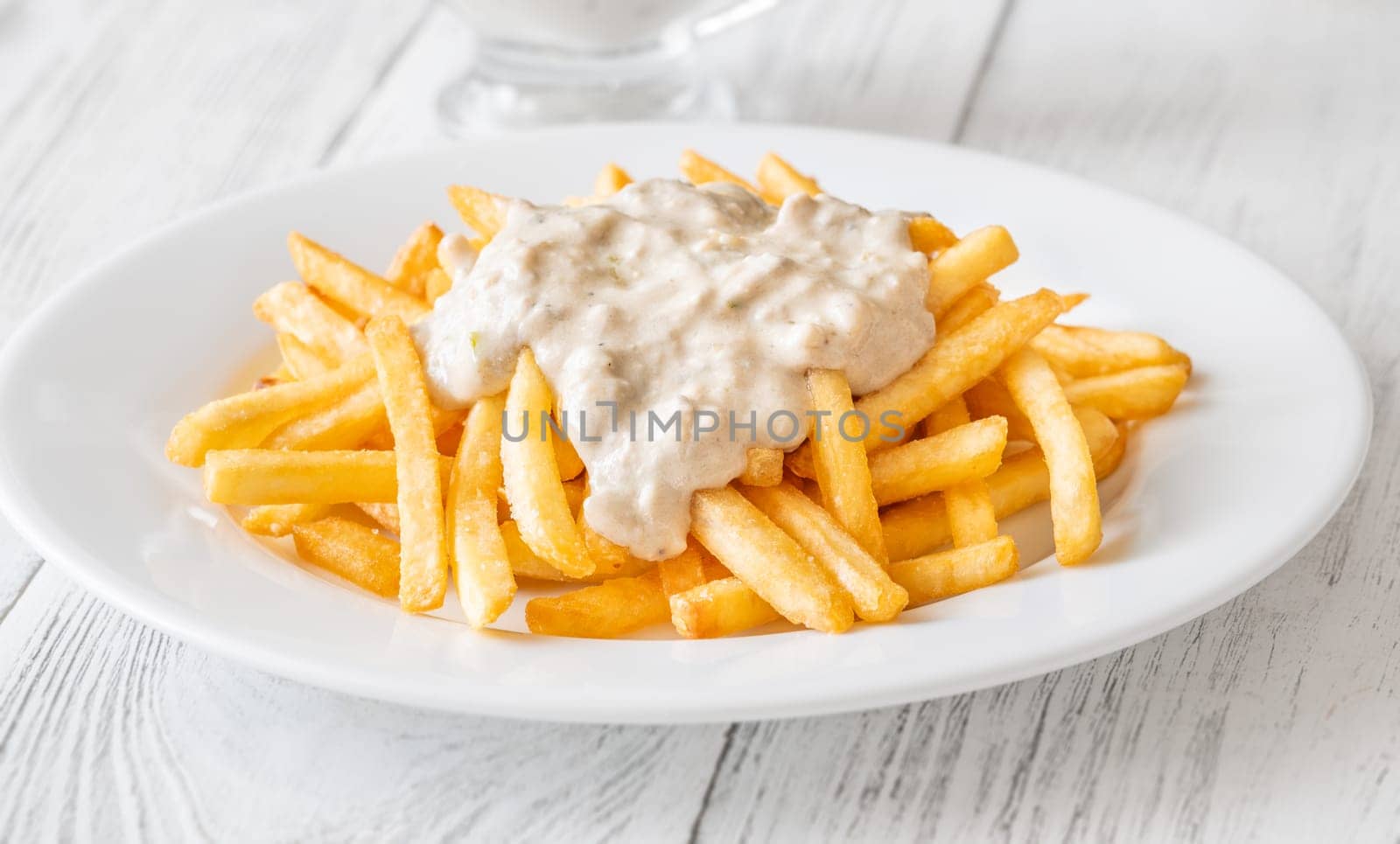 Creamy sauce melts into warm fries, creating a bold flavor experience together