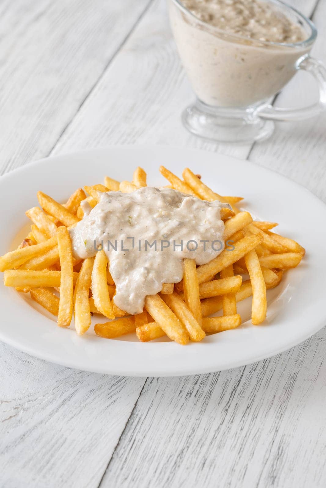 Creamy sauce melts into warm fries, creating a bold flavor experience together