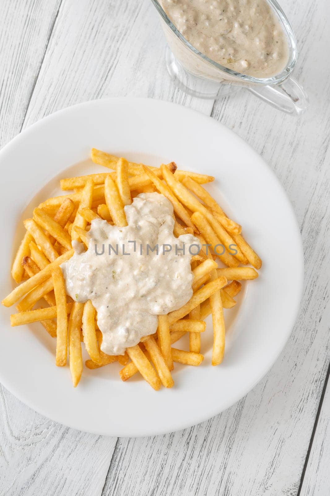 Creamy sauce melts into warm fries, creating a bold flavor experience together