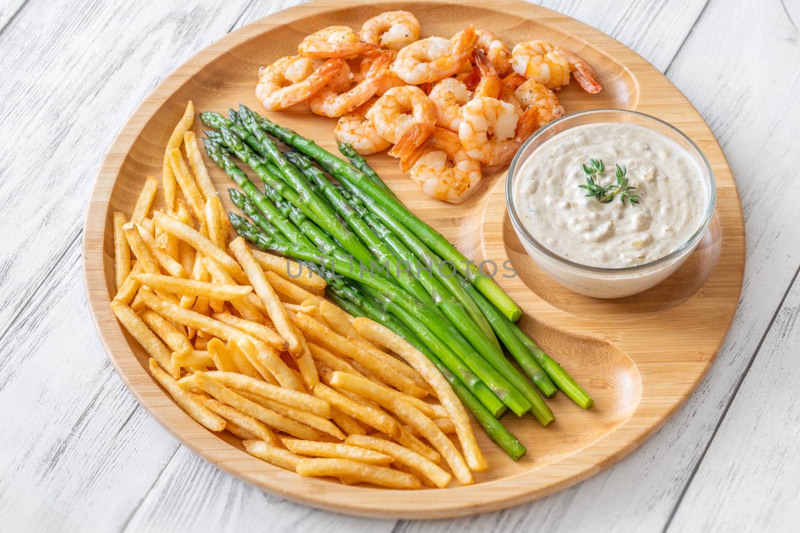 Crispy shrimp and fries balance soft asparagus and creamy sauce with thyme