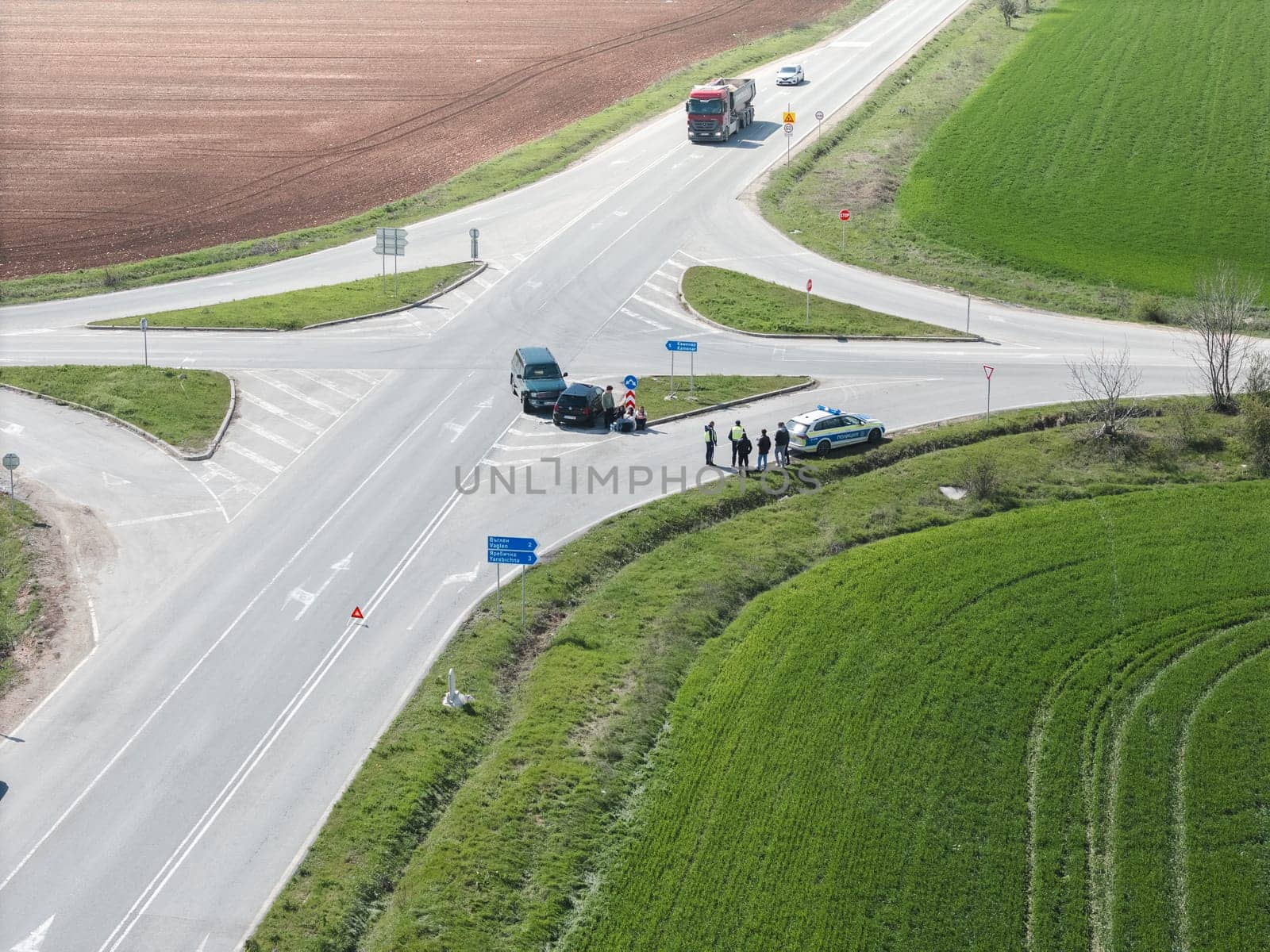 Aerial view Car crash accident at intersection on street, damaged vehicles after collision. Traffic police draw up a traffic accident report.