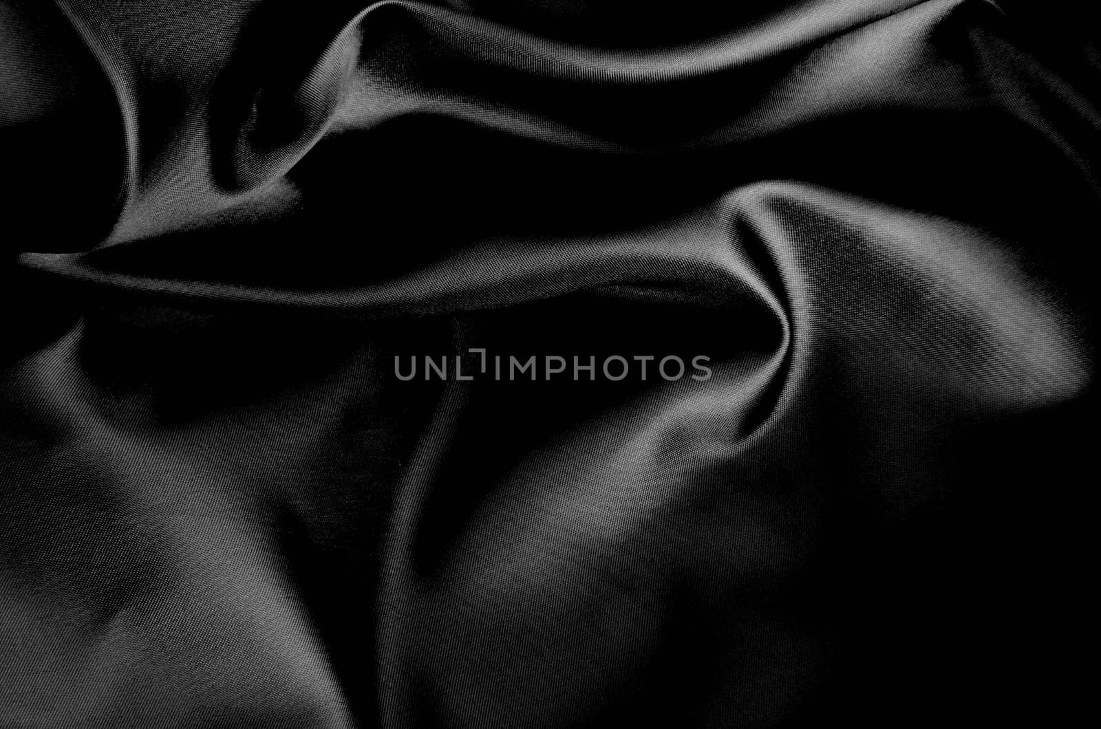 Top view of dark fabric showing smooth texture. Suitable for design and wallpaper background.