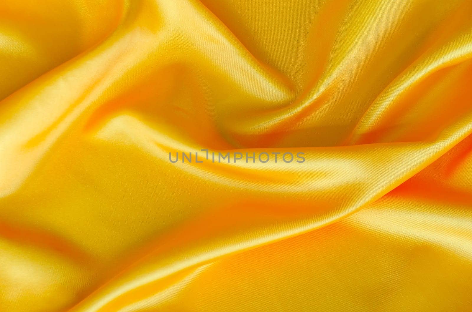 Polished yellow silk cloth with silky sheen and beautiful natural draping. Suitable for design and wallpaper background.