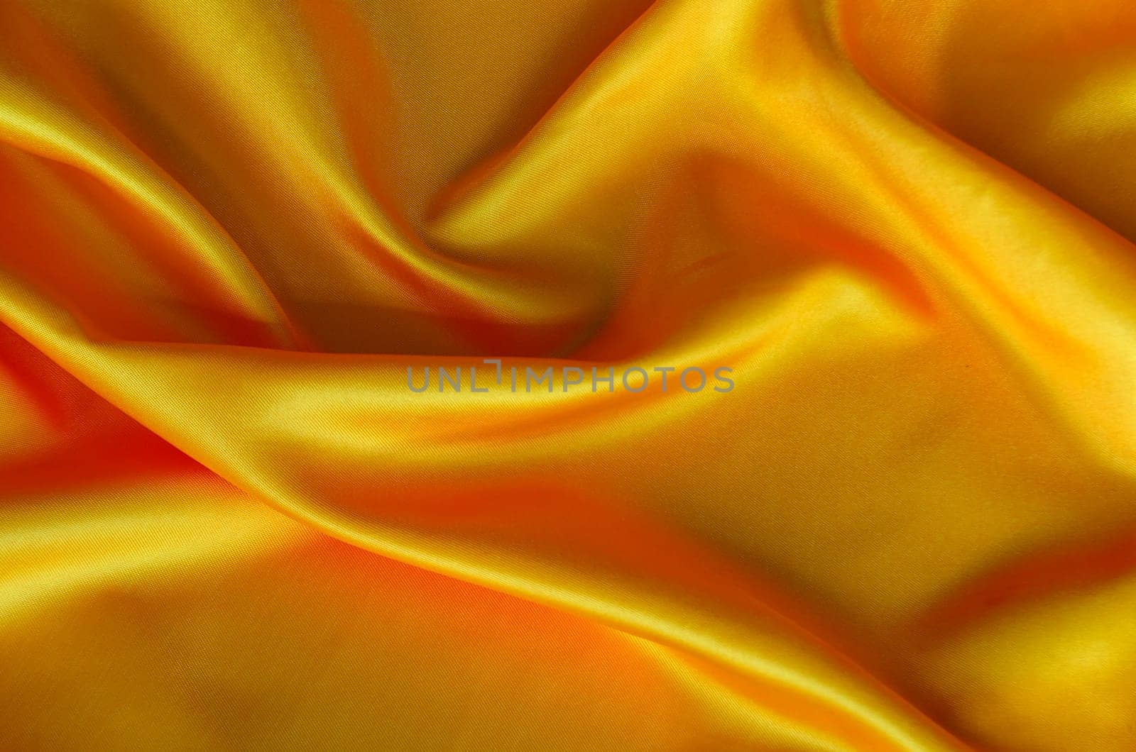 Polished golden silk cloth with silky sheen and beautiful natural draping. Suitable for design and wallpaper background.