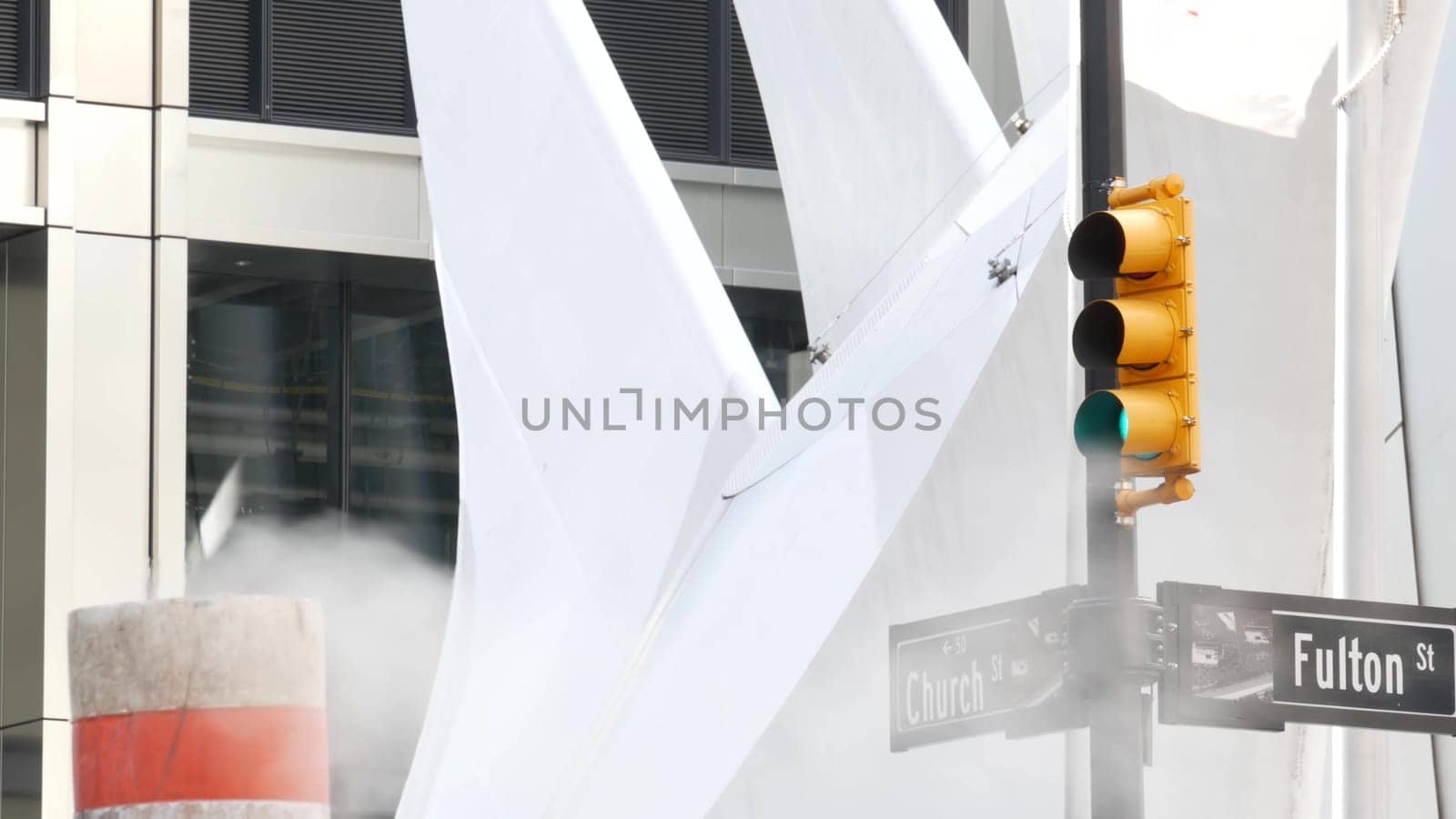 New York City, United States - 31 Aug 2023: Steam vapor vented, Church, Fulton street, orange tube stack. Hot smoke pipe. Con Edison Steam Operations system, Manhattan downtown financial district.