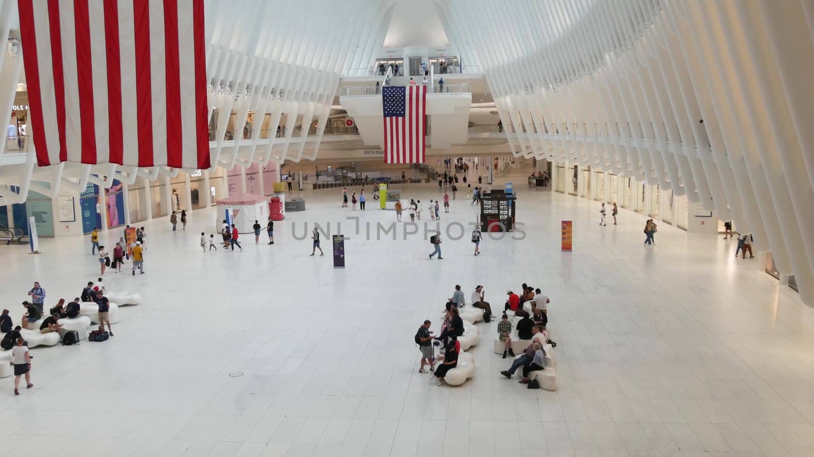 New York City, United States - 10 Sept 2023: World Trade Center Oculus transport hub architecture. Manhattan Downtown Financial District, USA urban life. People. September 11 remembrance american flag