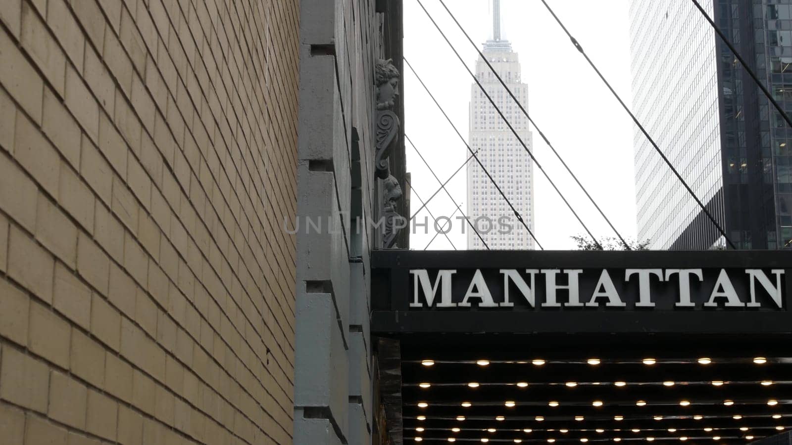 New York City, United States - 29 Aug 2023: Manhattan Center, Midtown 34 street architecture. Empire State building, iconic high-rise skyscraper in USA. American urban cityscape, famous NYC tower.