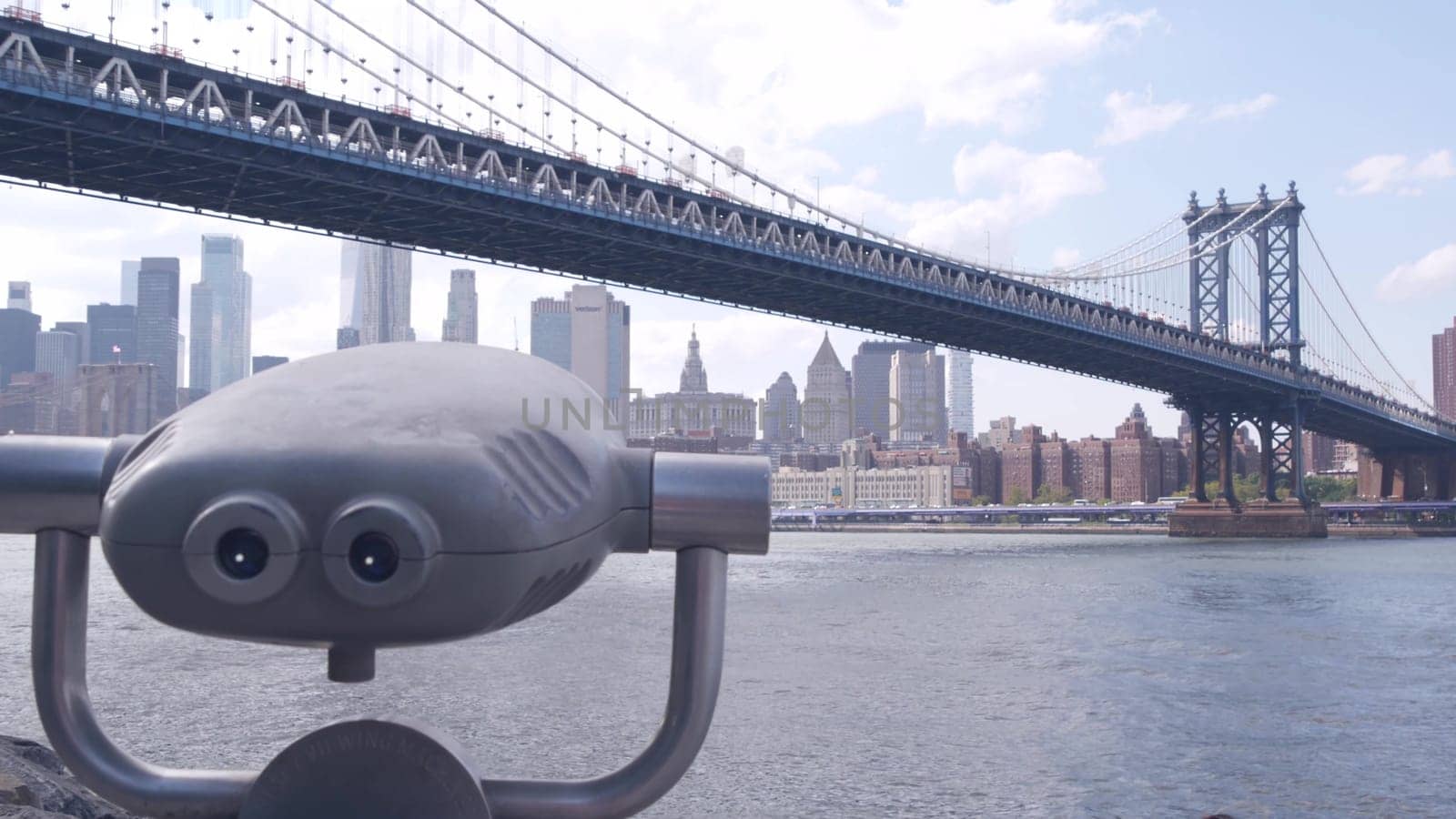 New York City, United States - 30 Aug 2023: Manhattan Bridge lookout, tower viewer binoculars, Brooklyn Dumbo. Waterfront downtown cityscape, skyscraper skyline. East River tourist promenade.
