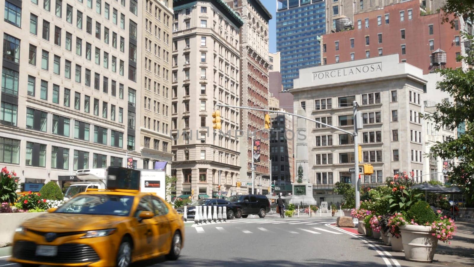 New York City, United States - 6 Sept 2023: Manhattan Midtown Broadway, 23 street, 5 avenue crossroad intersection. Worth Square near Madison Park, Flatiron, USA. Porcelanosa. People. Yellow taxi car