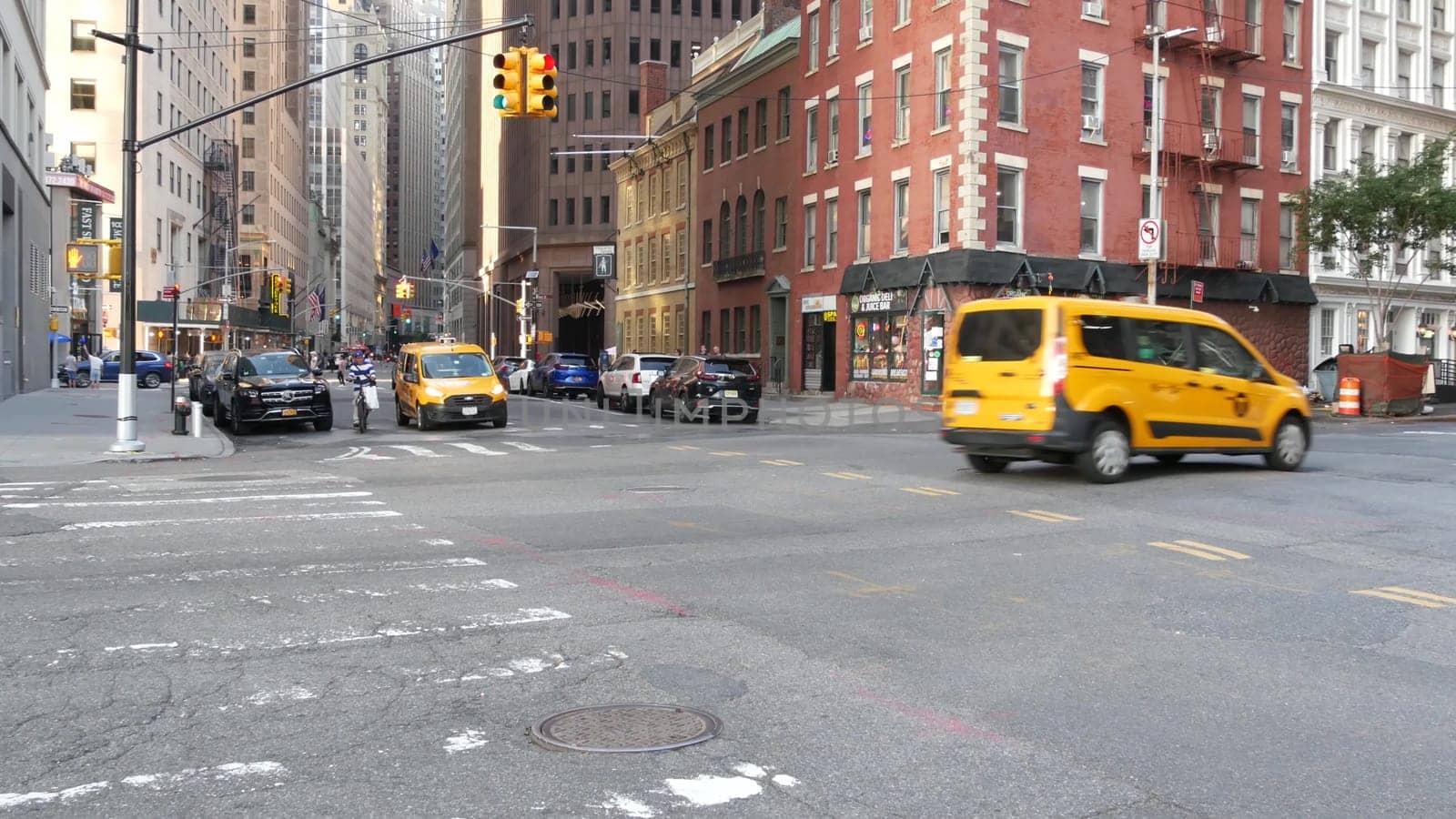 New York City, United States - 4 Sept 2023: Manhattan Downtown Financial District Water, Pearl and Broad street crossroad intersection. USA city life. Road car traffic. Yellow taxi. People pedestrian.