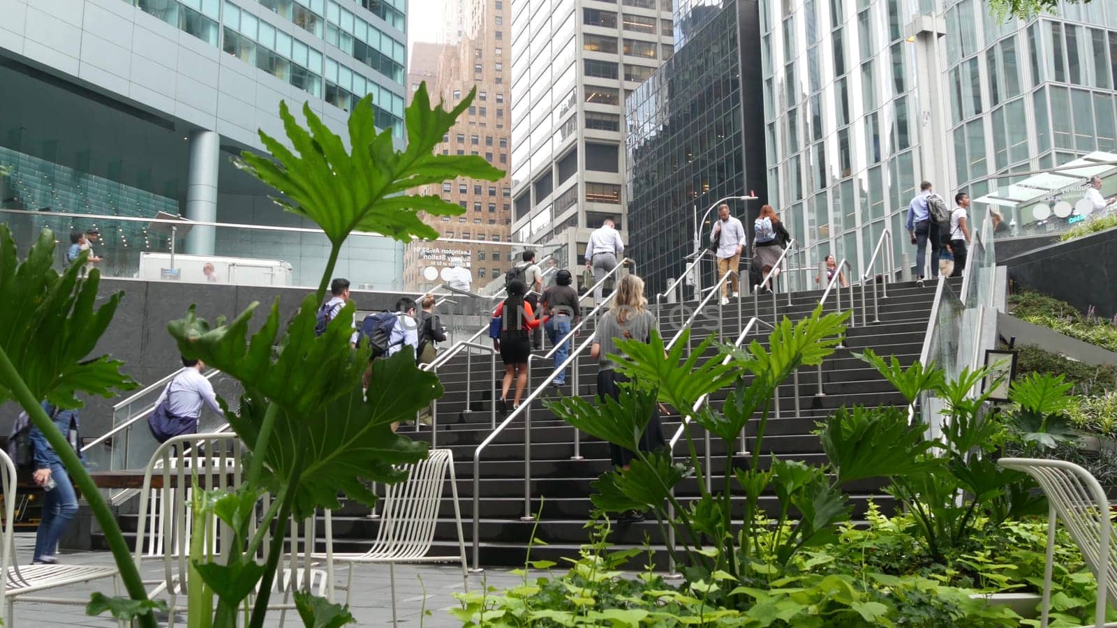 New York City, United States - 11 Sept 2023: Manhattan Midtown office buildings, Lexington avenue, United States. People pedestrian exiting subway metro station, stairs on 53 street, USA urban life.