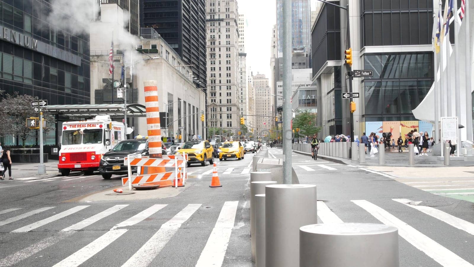New York City, United States - 10 Sept 2023: Manhattan Downtown Church and Fulton street traffic, crossroad intersection zebra. Yellow taxi car. People near USA World Trade Center Oculus. Smoke stack.