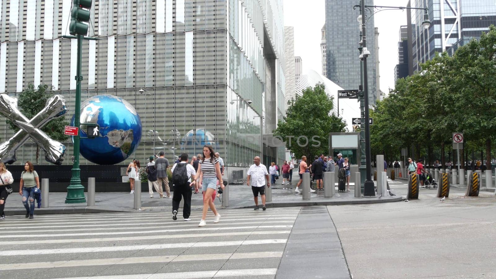 New York City, United States - 10 Sept 2023: Manhattan Downtown Financial District street crossroad intersection. Urban road car traffic. People pedestrian on zebra. World Trade Center memorial area.