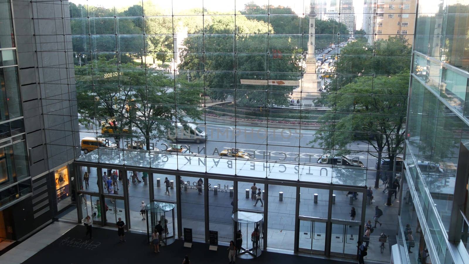 New York City, United States - 14 Sept 2023: Columbus Circle, Broadway street near Central Park. Manhattan Midtown architecture. USA urban road traffic thru window of Deutsche Bank Center. Yellow taxi