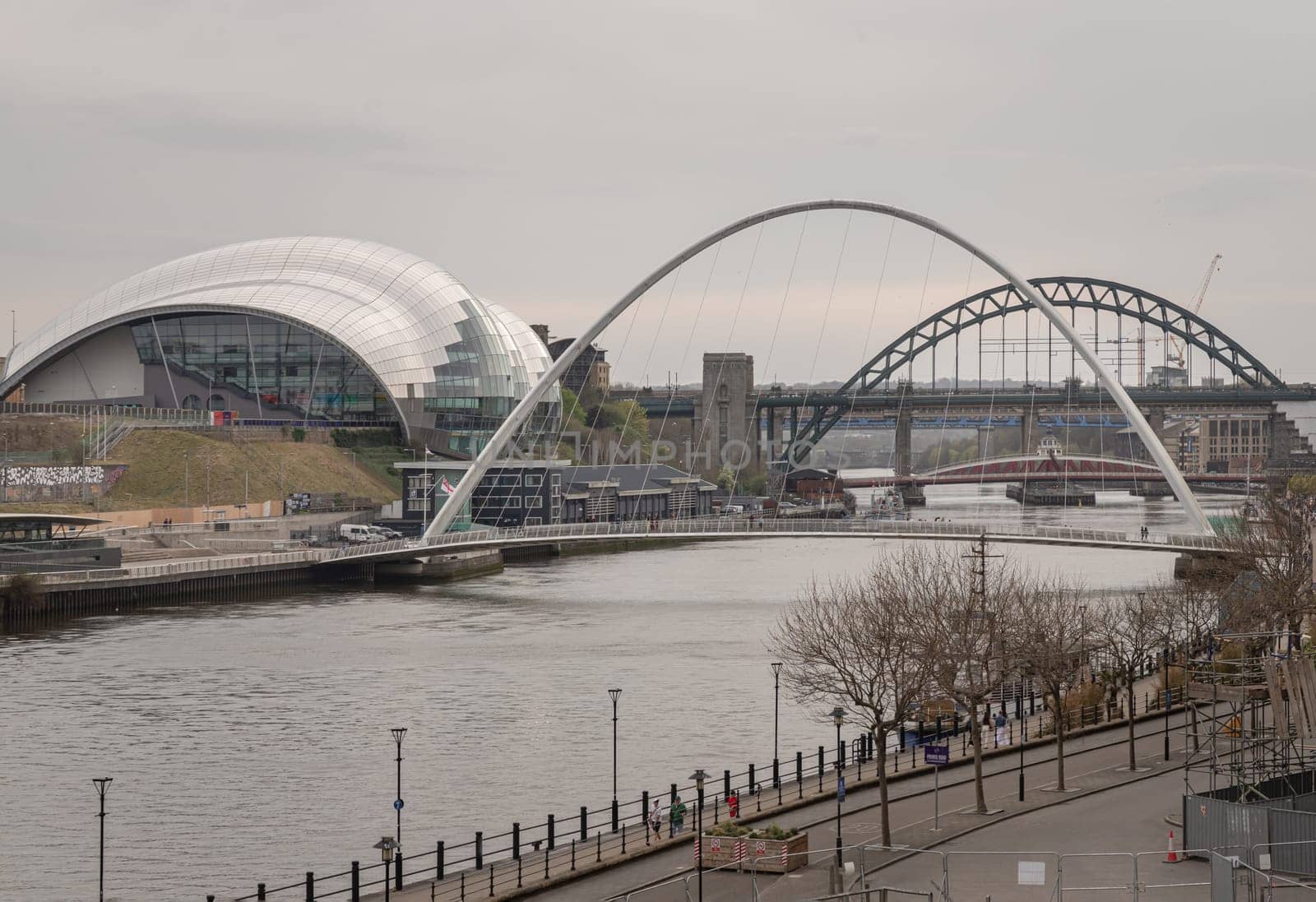 Newcastle, UK - Apr 12, 2025 - Stunning view of The Iconic gateshead millennium bridge spanning the River Tyne with Sage Gateshead and Tyne bridge in the background. use it as your Wallpaper, Poster and Space for text, Selective focus.