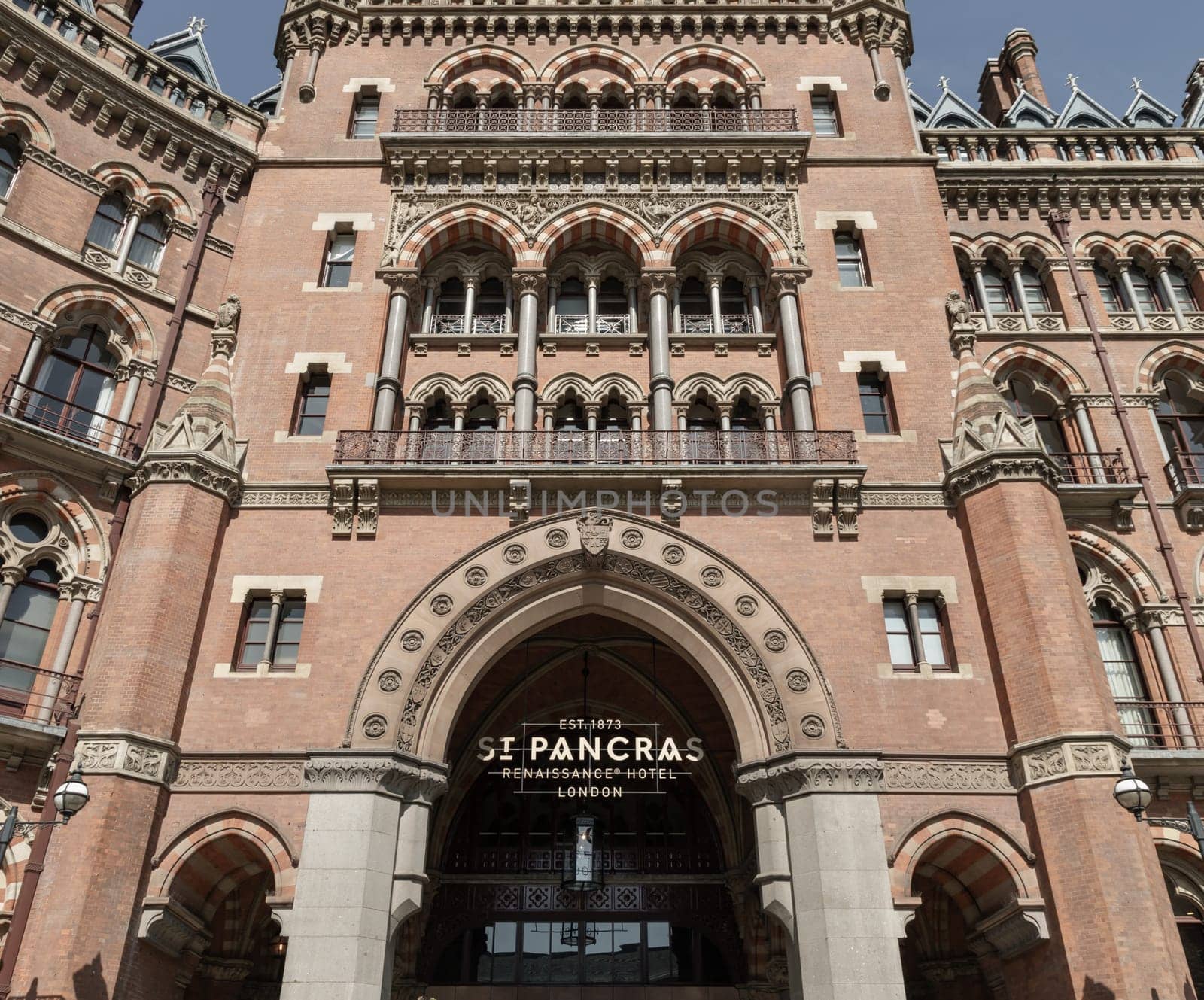 London, UK - Apr 11, 2025 - Facade of the gothic building where the St. Pancras Renaissance Hotel is based in Kings Cross. Stunning outside entrance of Victorian architecture at the Midland Grand Hotel, use it as your Wallpaper, Poster and Space for text, Selective focus.