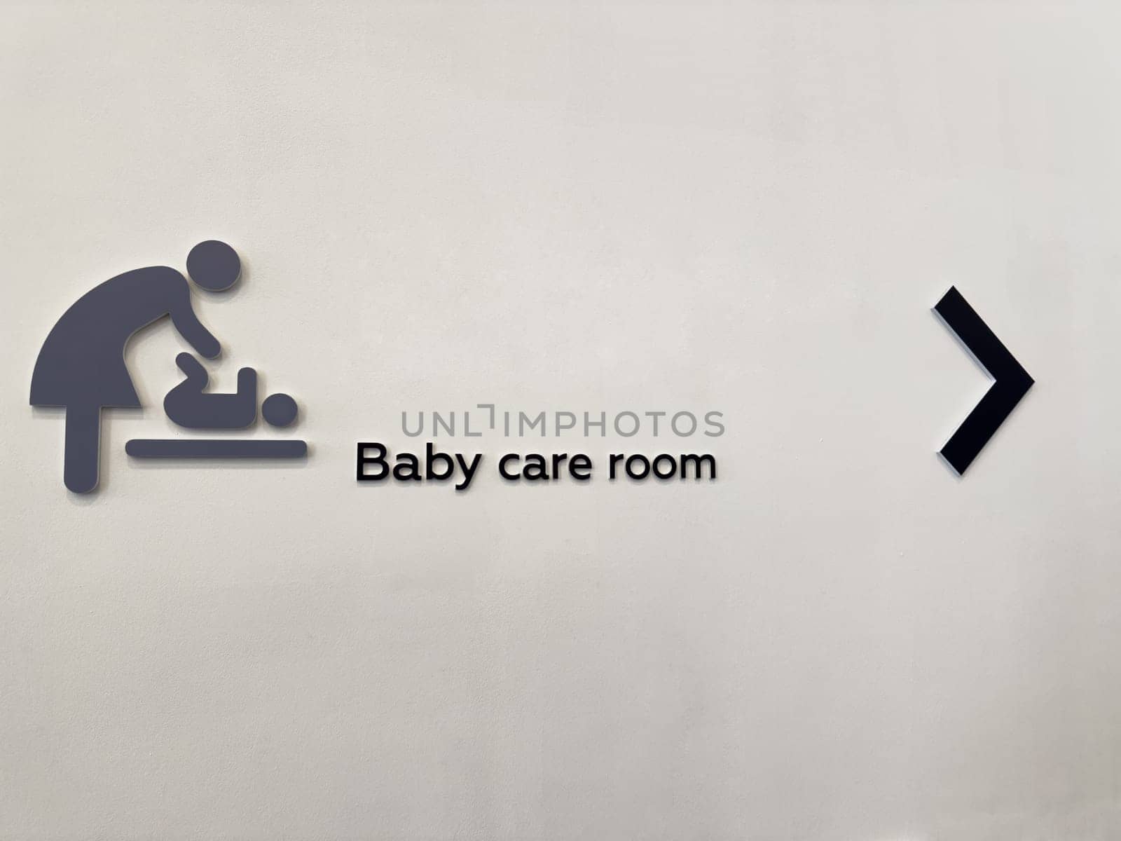 Inclusive baby care room sign in public space. Symbol of support for parents and caregivers. Promotes accessibility, equal opportunity, and family-friendly urban infrastructure