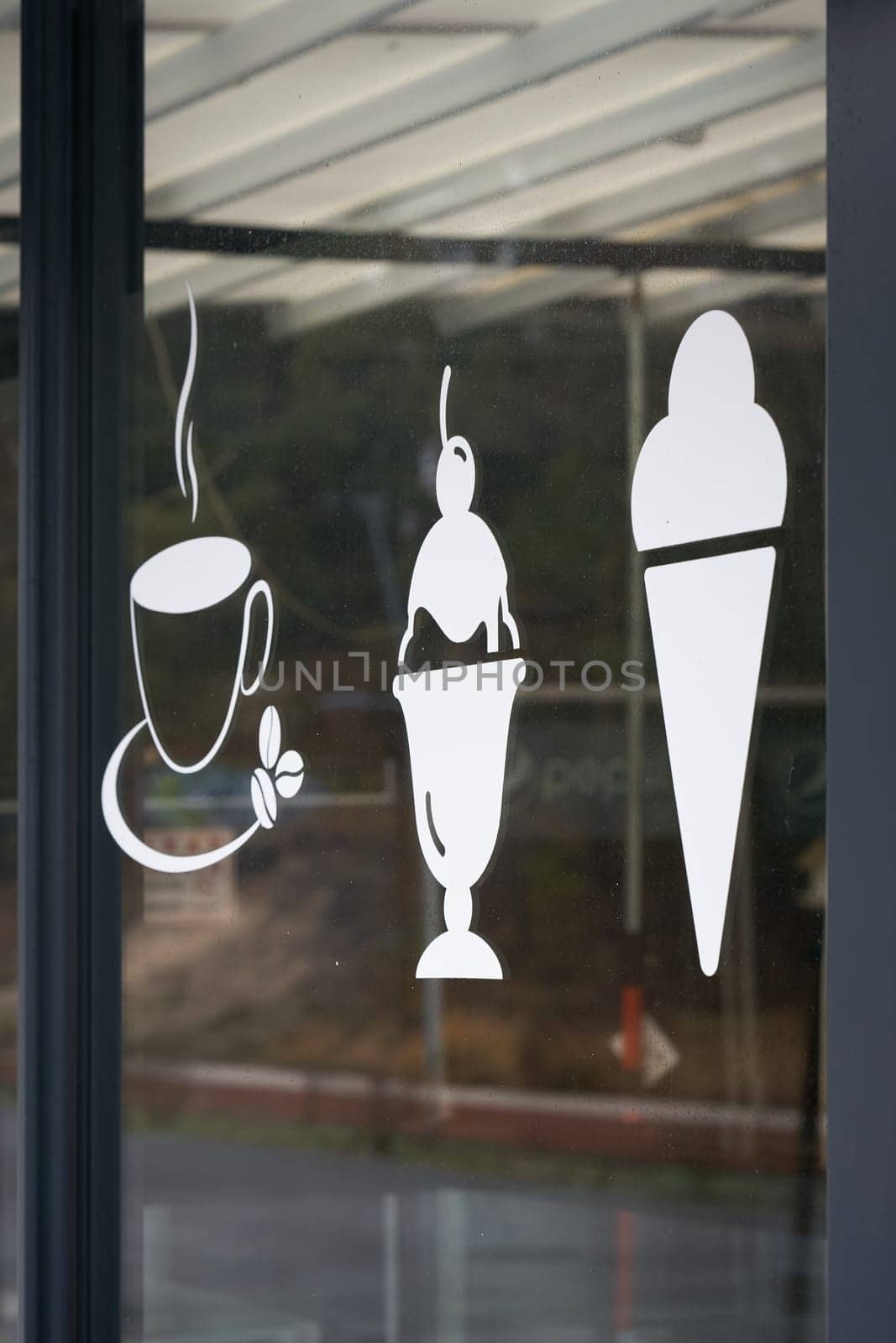 Symbols on the shop window indicating a café in the center of Swinoujscie in Poland