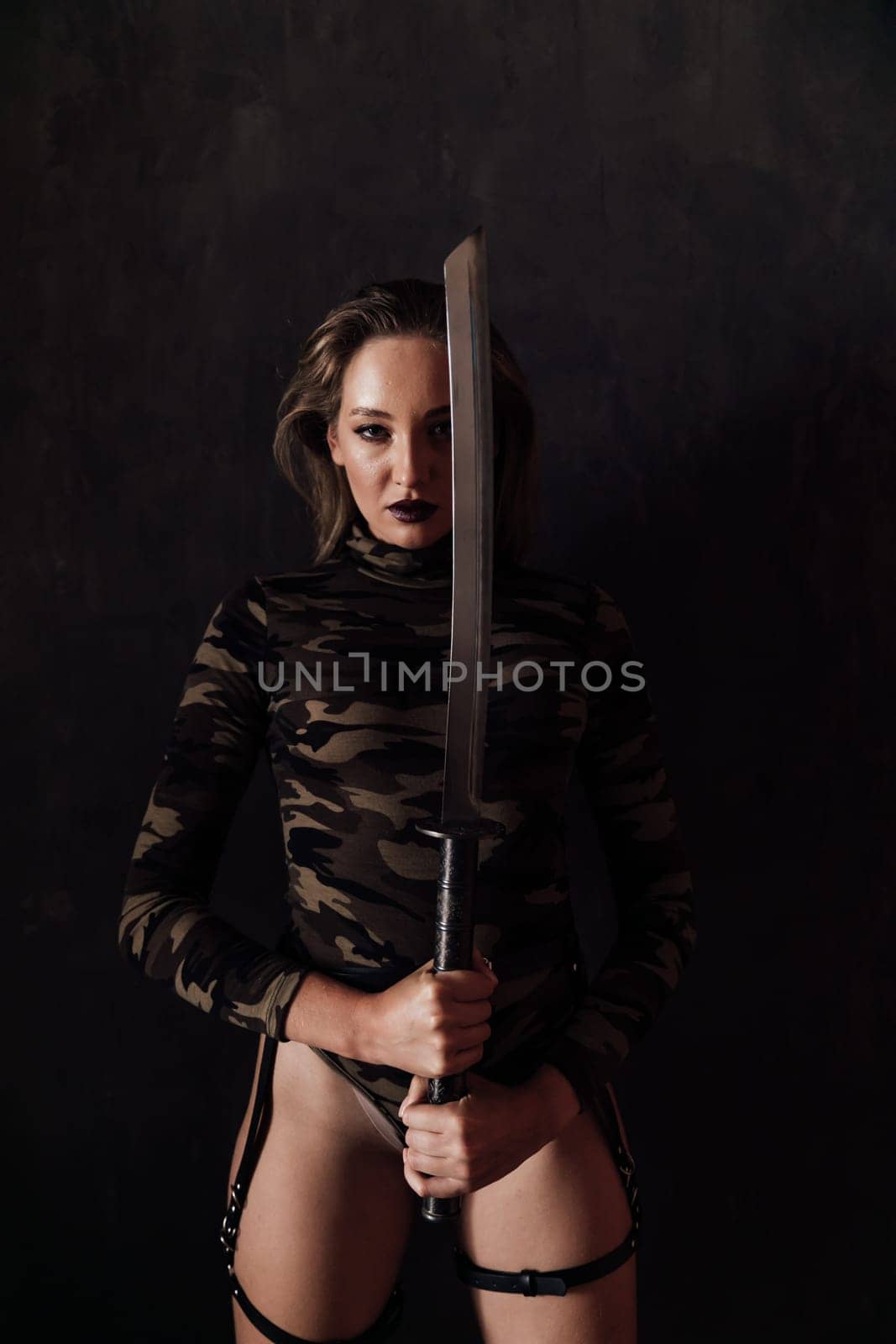 Slim fashionable military woman with Japanese katana