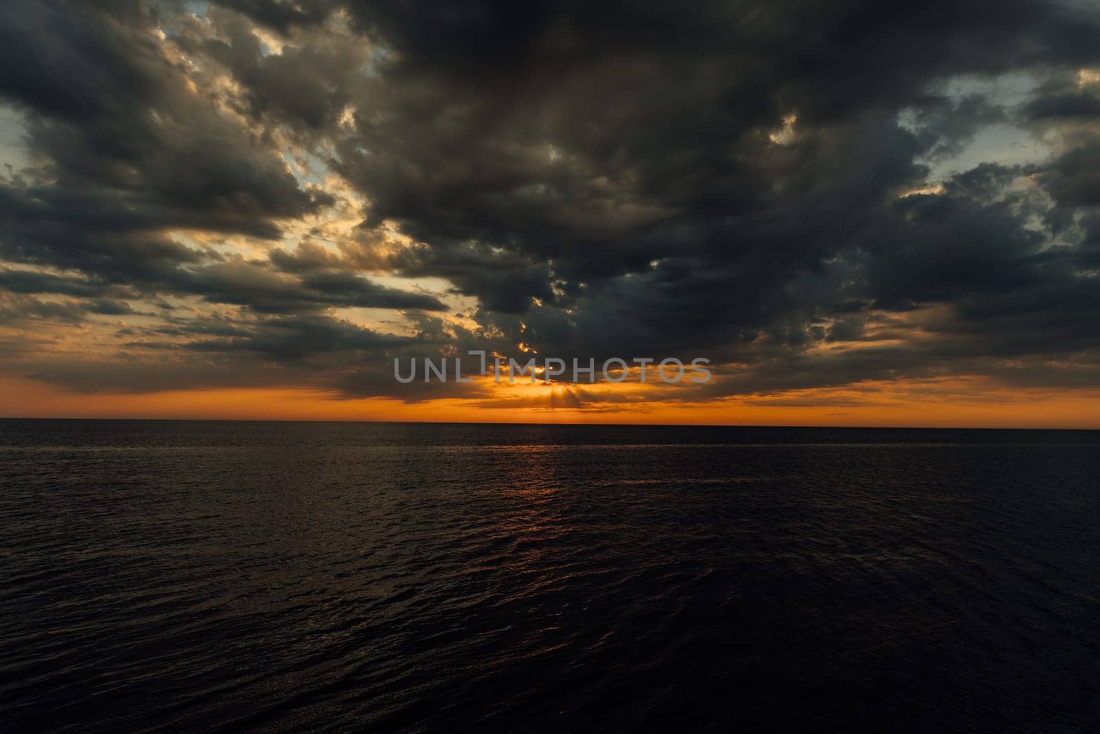 Beautiful landscape on the sea and horizon with the setting sun in the clouds